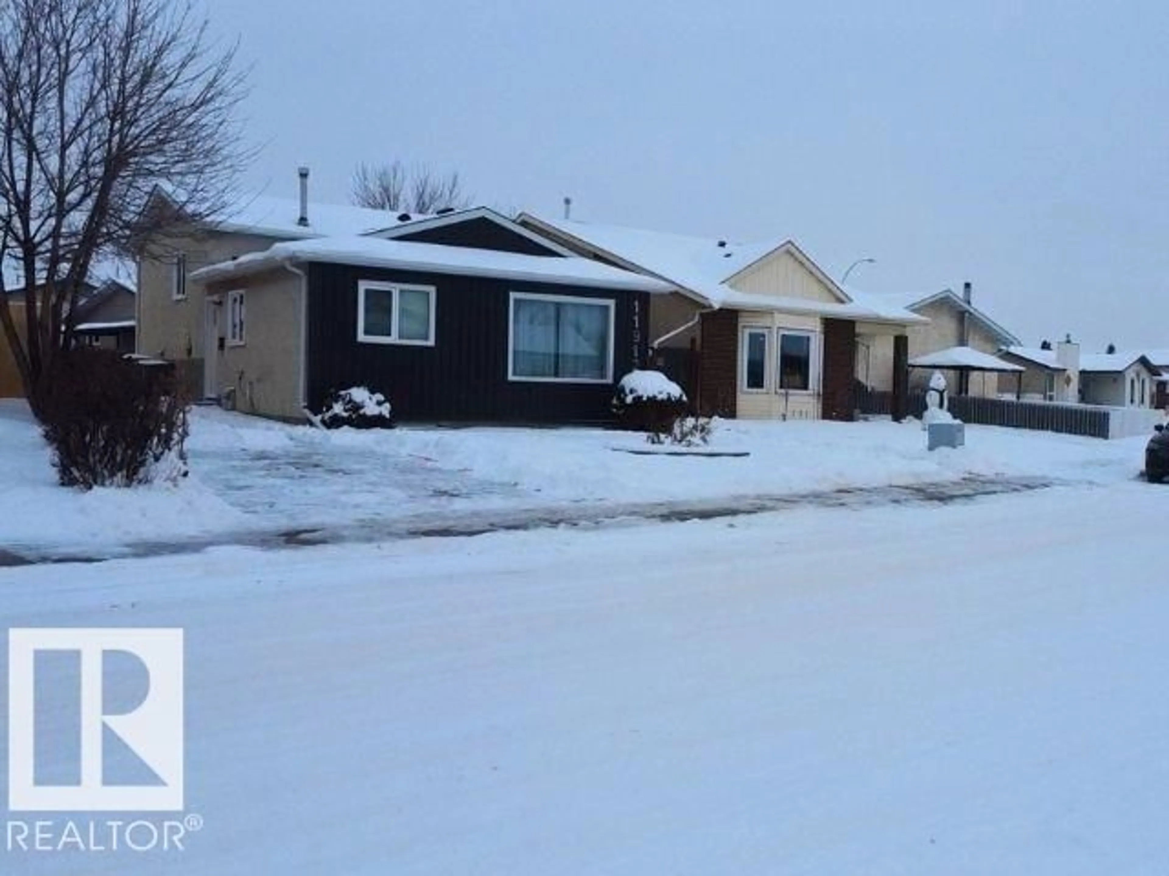 Home with vinyl exterior material, street for 11912 140 AV, Edmonton Alberta T5X5K1