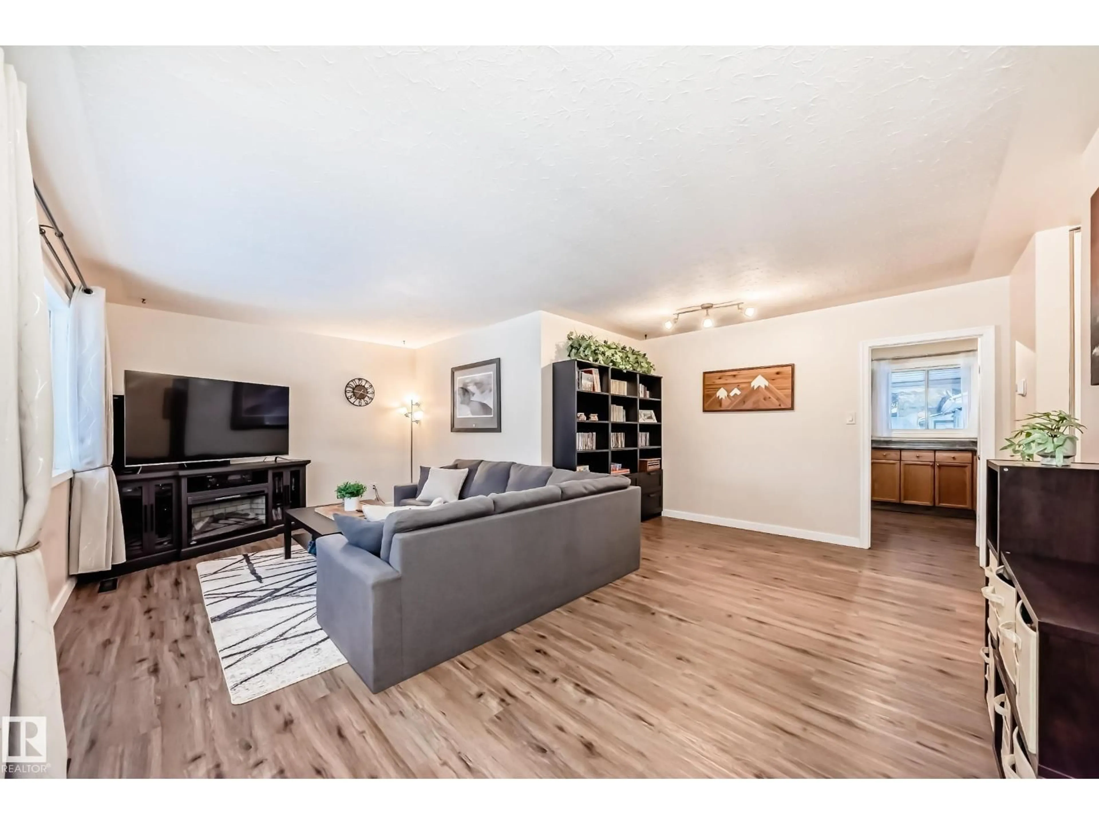 Living room with furniture, wood/laminate floor for NW - 13032 134 ST, Edmonton Alberta T5L1V8