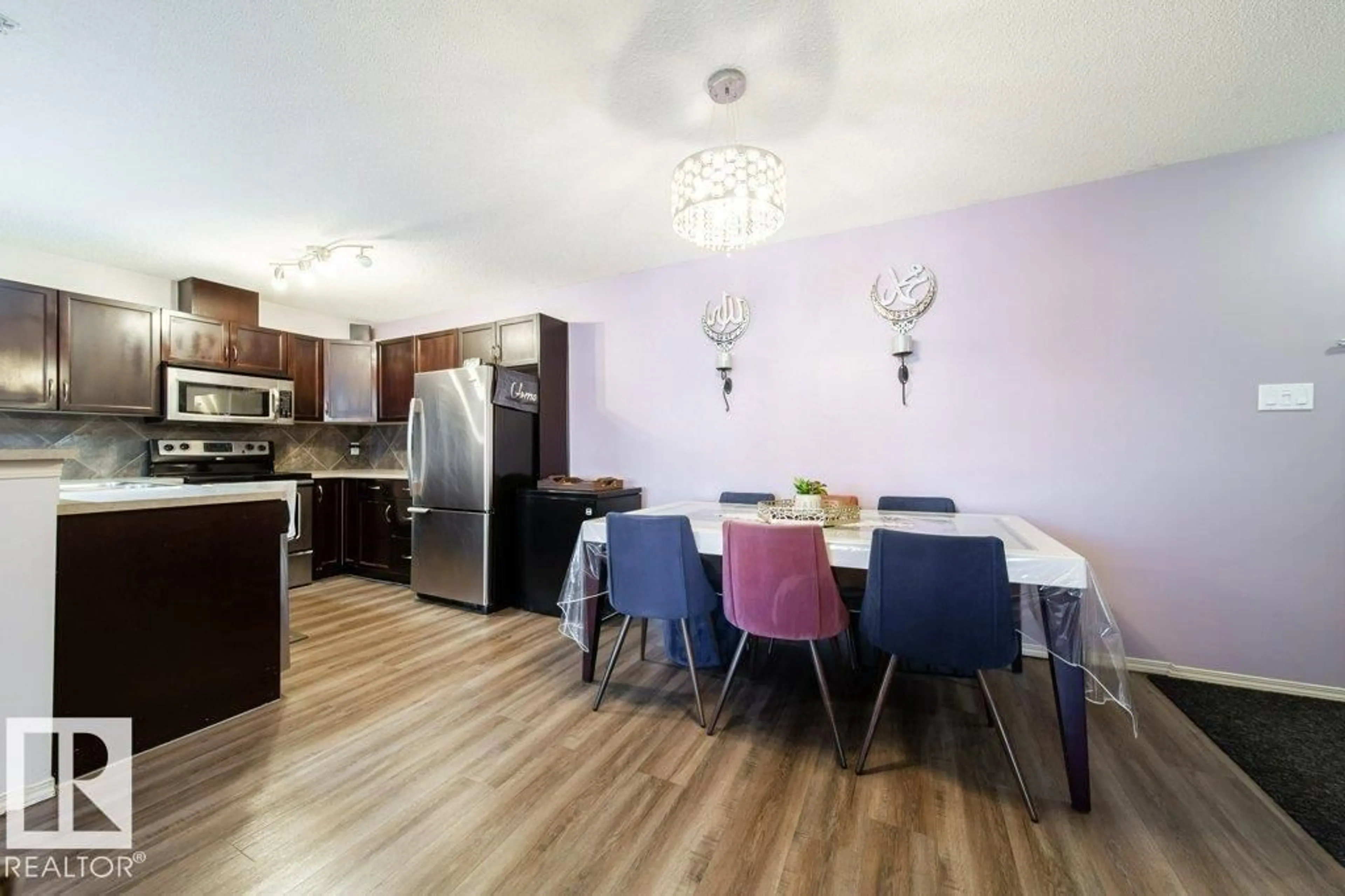 Open concept kitchen, wood/laminate floor for 105 - 5951 165 AV, Edmonton Alberta T5Y0J6