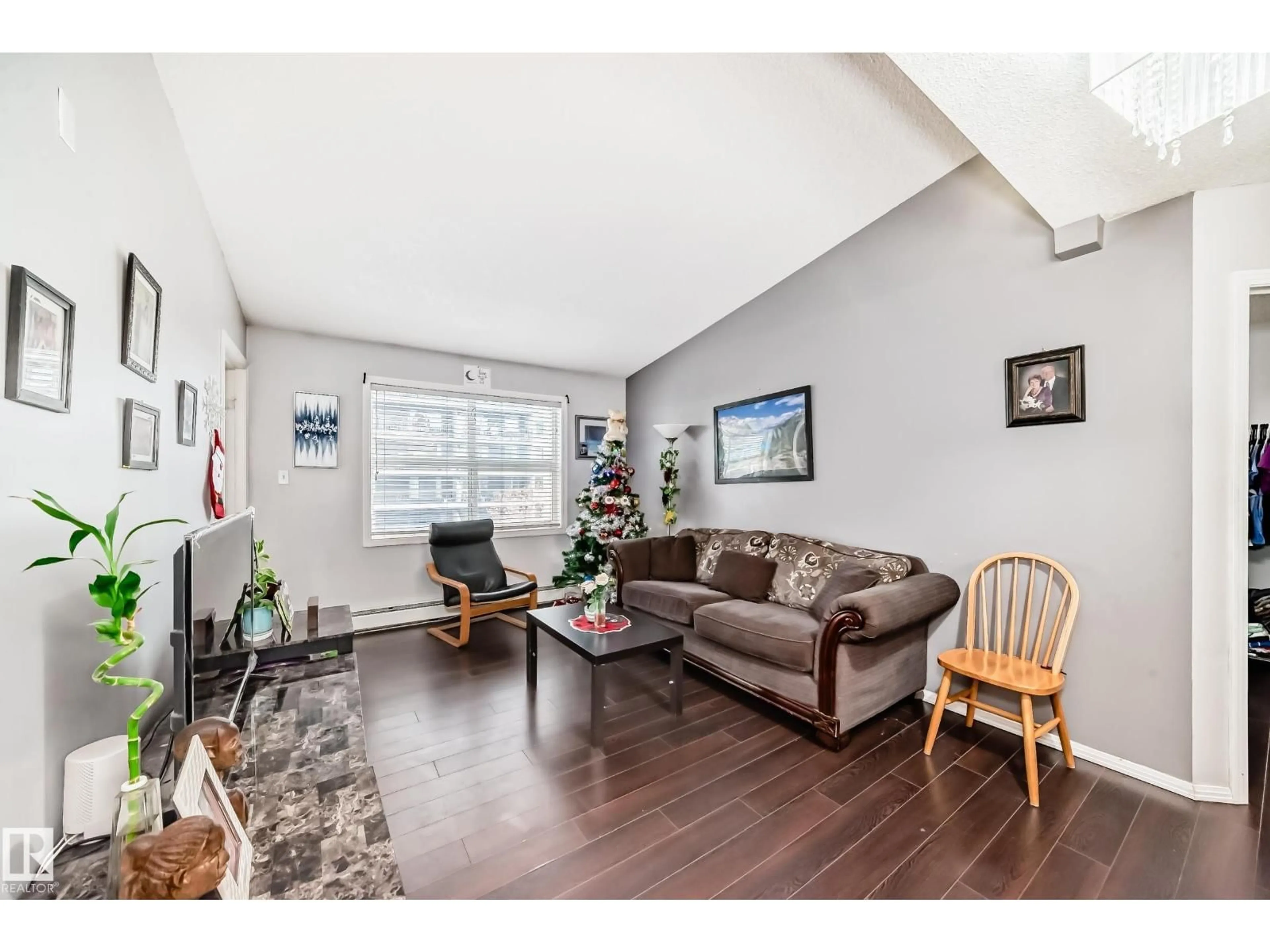 Living room with furniture, wood/laminate floor for 422 12838 65 ST NW, Edmonton Alberta T5A5H3