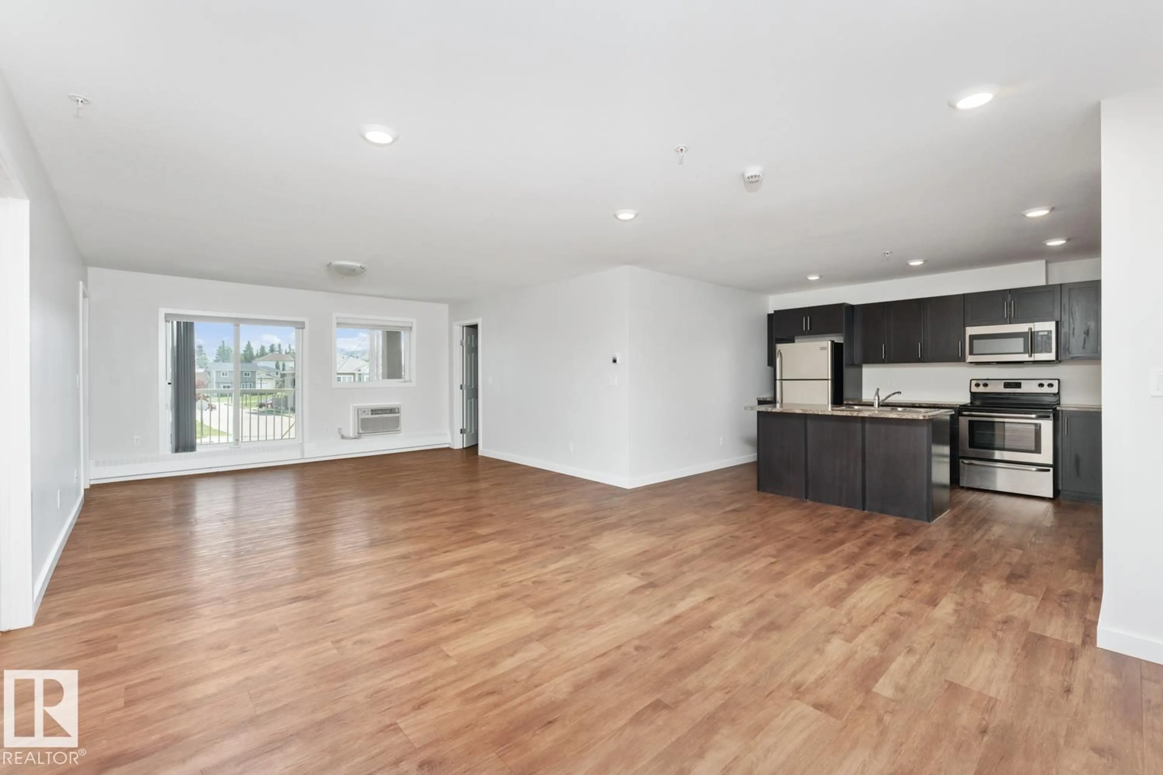 Open concept kitchen, wood/laminate floor for #1103 - 1601 8 AV, Cold Lake Alberta T9M0C3
