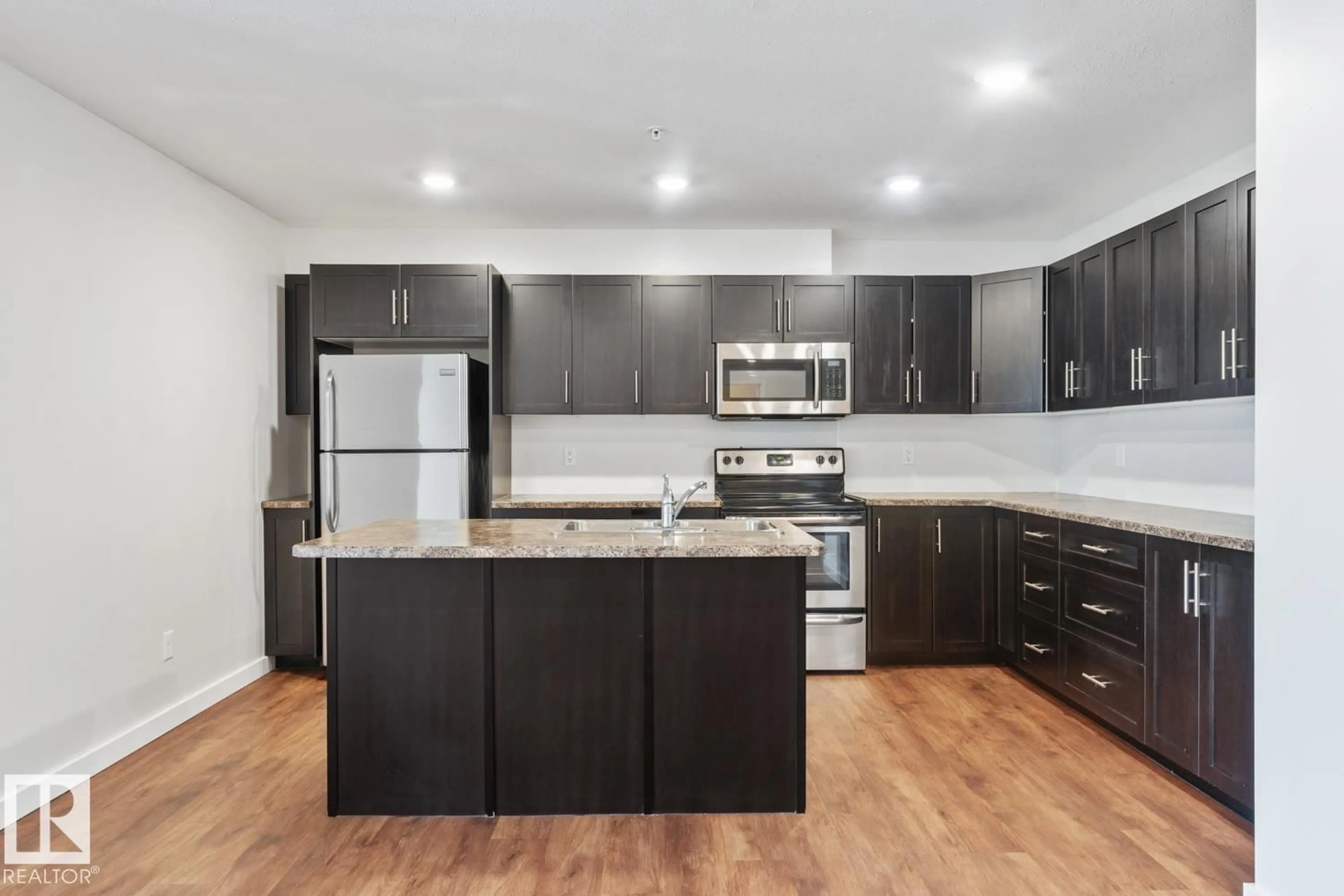 Open concept kitchen, wood/laminate floor for #1103 - 1601 8 AV, Cold Lake Alberta T9M0C3