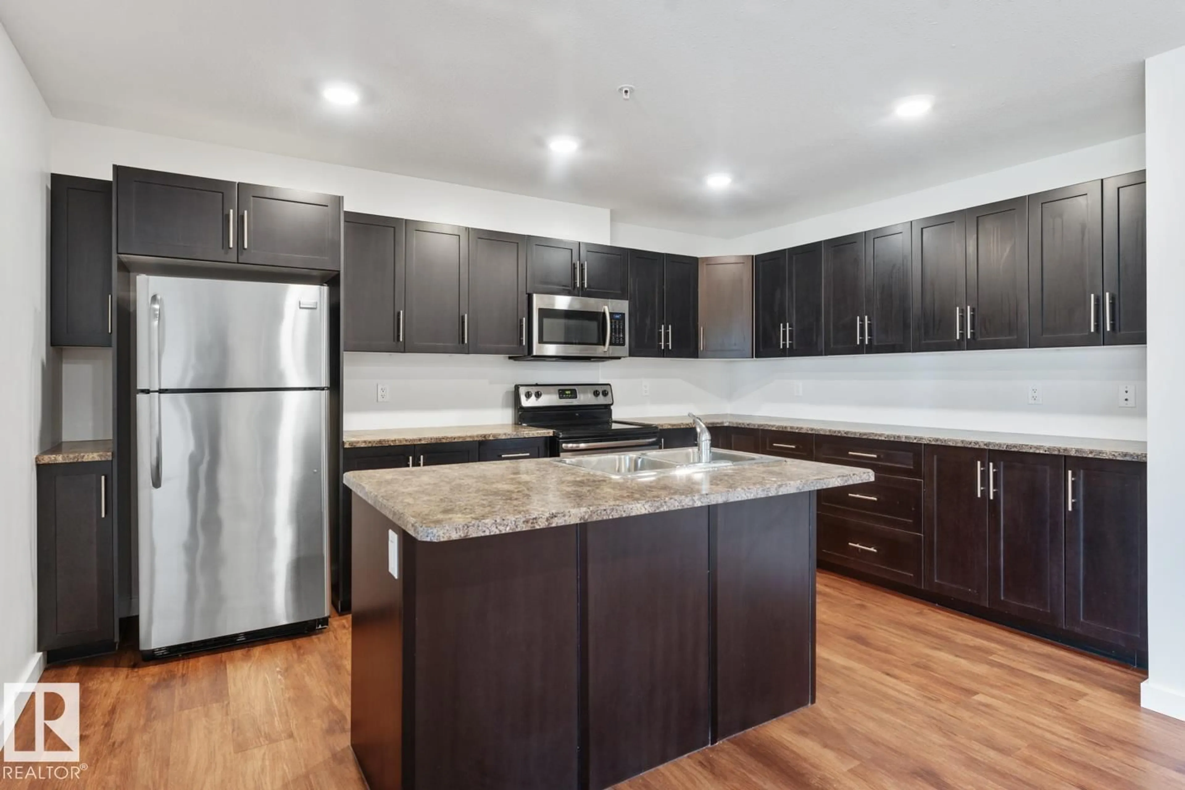 Open concept kitchen, wood/laminate floor for #1103 - 1601 8 AV, Cold Lake Alberta T9M0C3