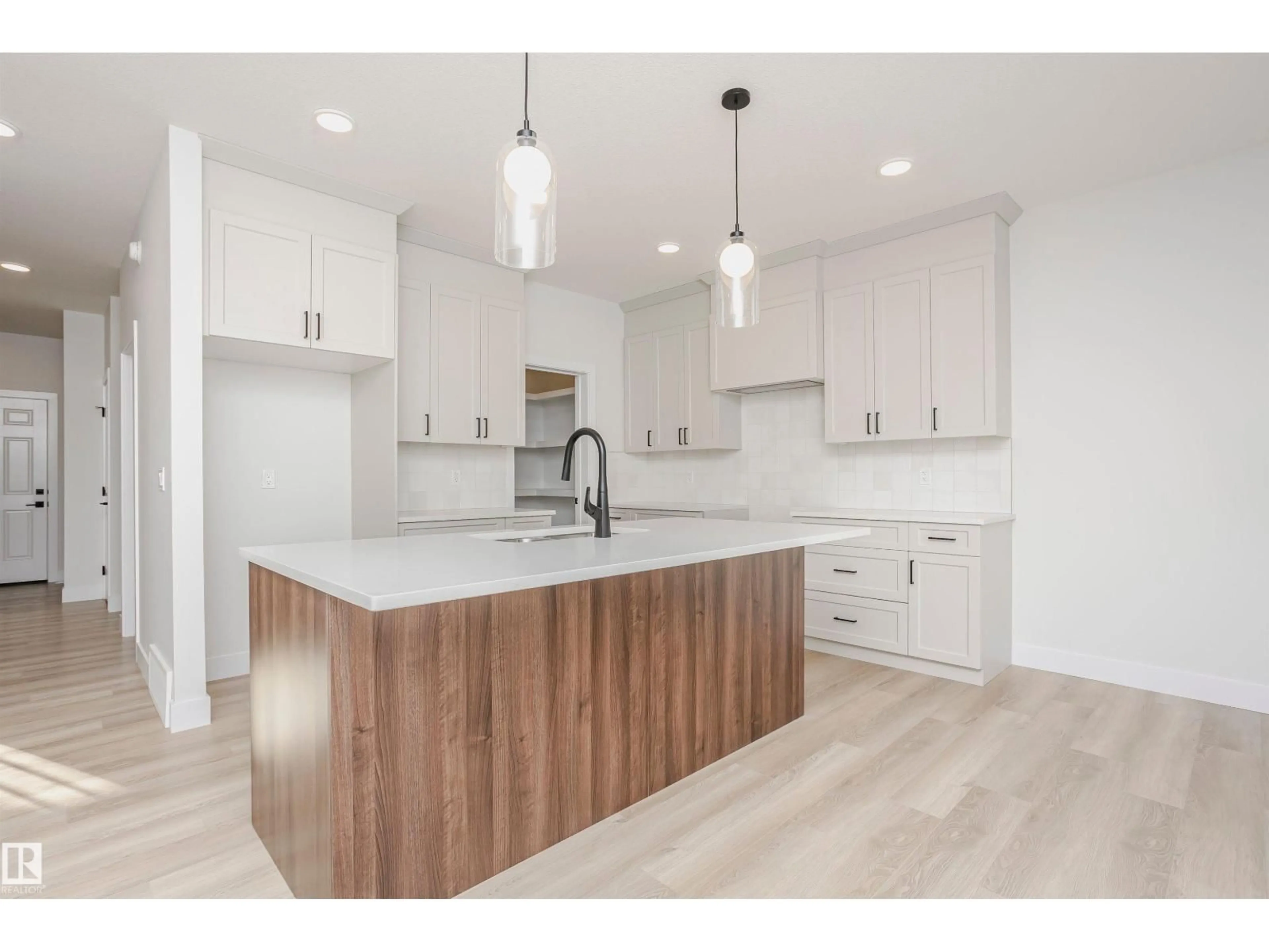 Open concept kitchen, wood/laminate floor for 6302 DANSEREAU CR, Beaumont Alberta T4X3E1