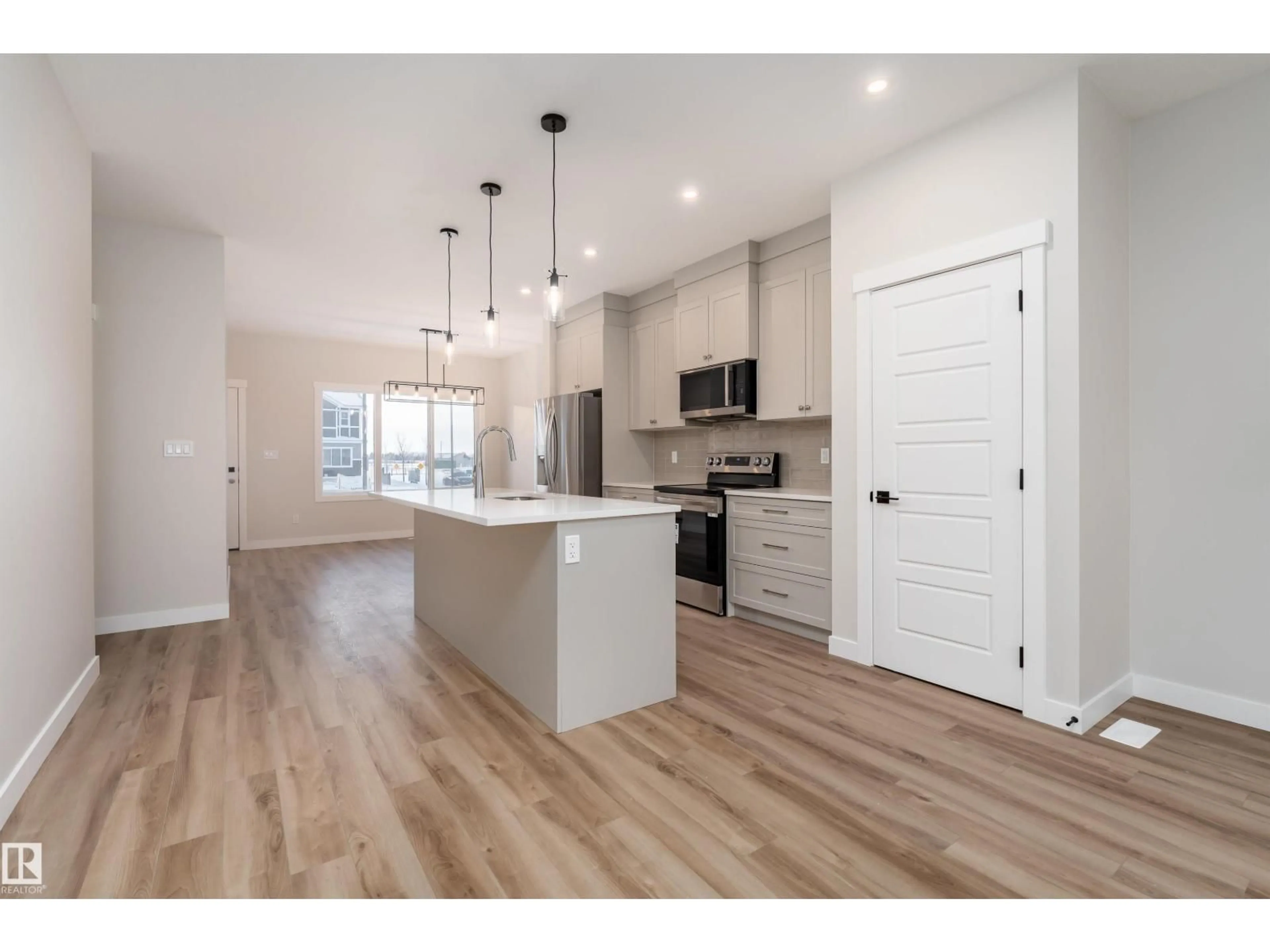 Open concept kitchen, wood/laminate floor for 8532 96 AVENUE, Morinville Alberta T8R2R6