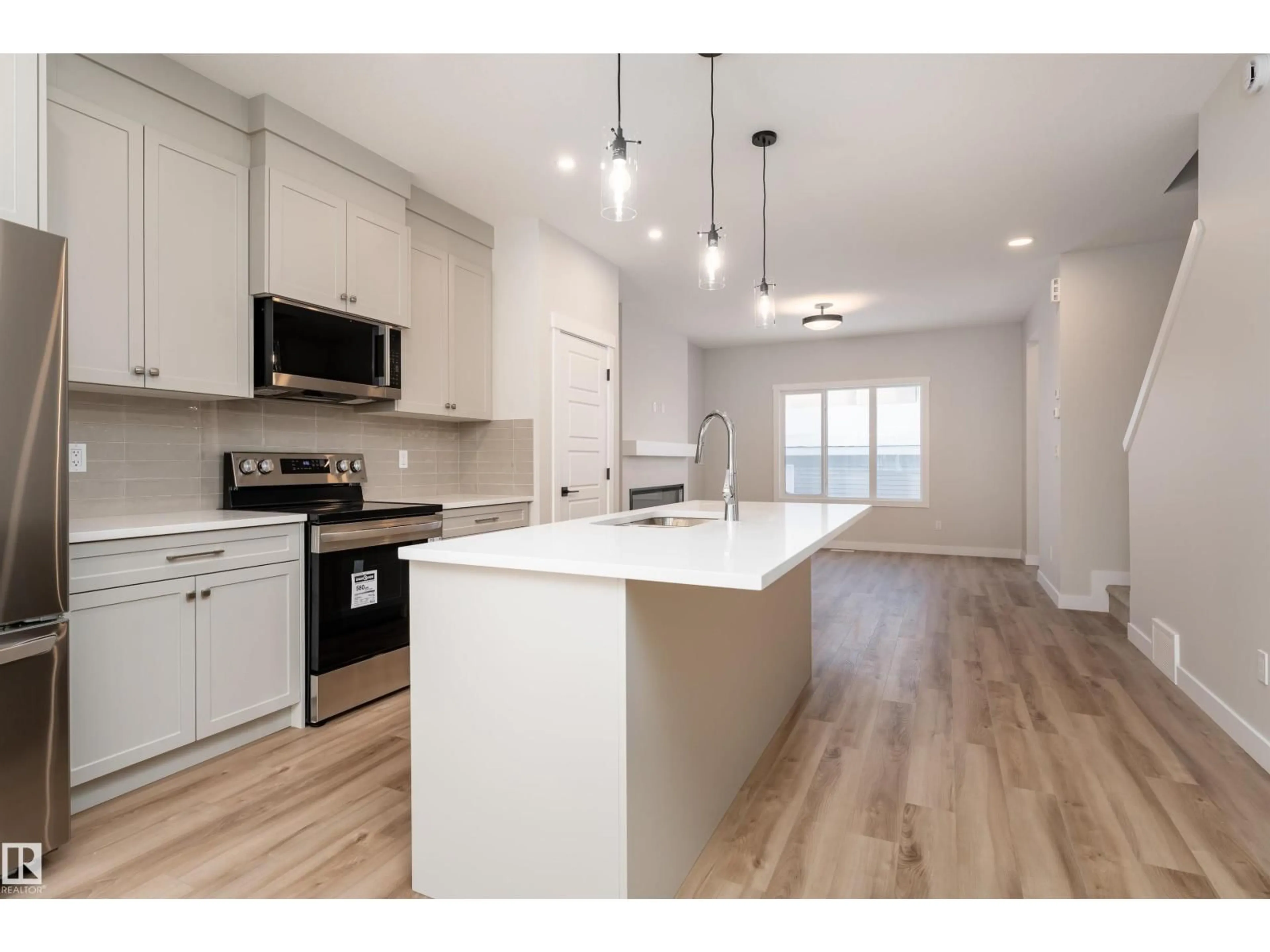 Open concept kitchen, wood/laminate floor for 8532 96 AVENUE, Morinville Alberta T8R2R6