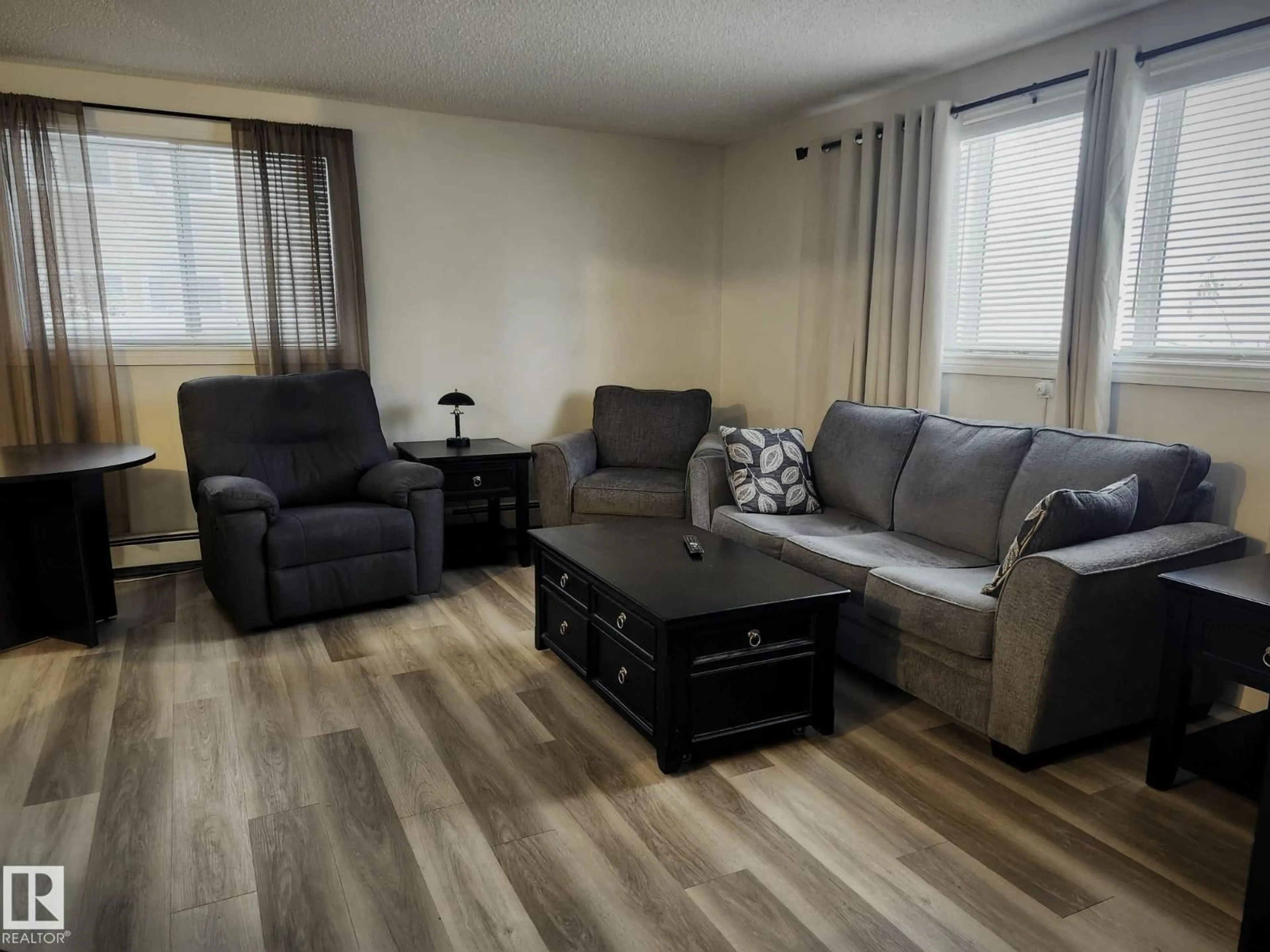 Living room with furniture, wood/laminate floor for #4 - 6120 118 AV, Edmonton Alberta T5W1E8