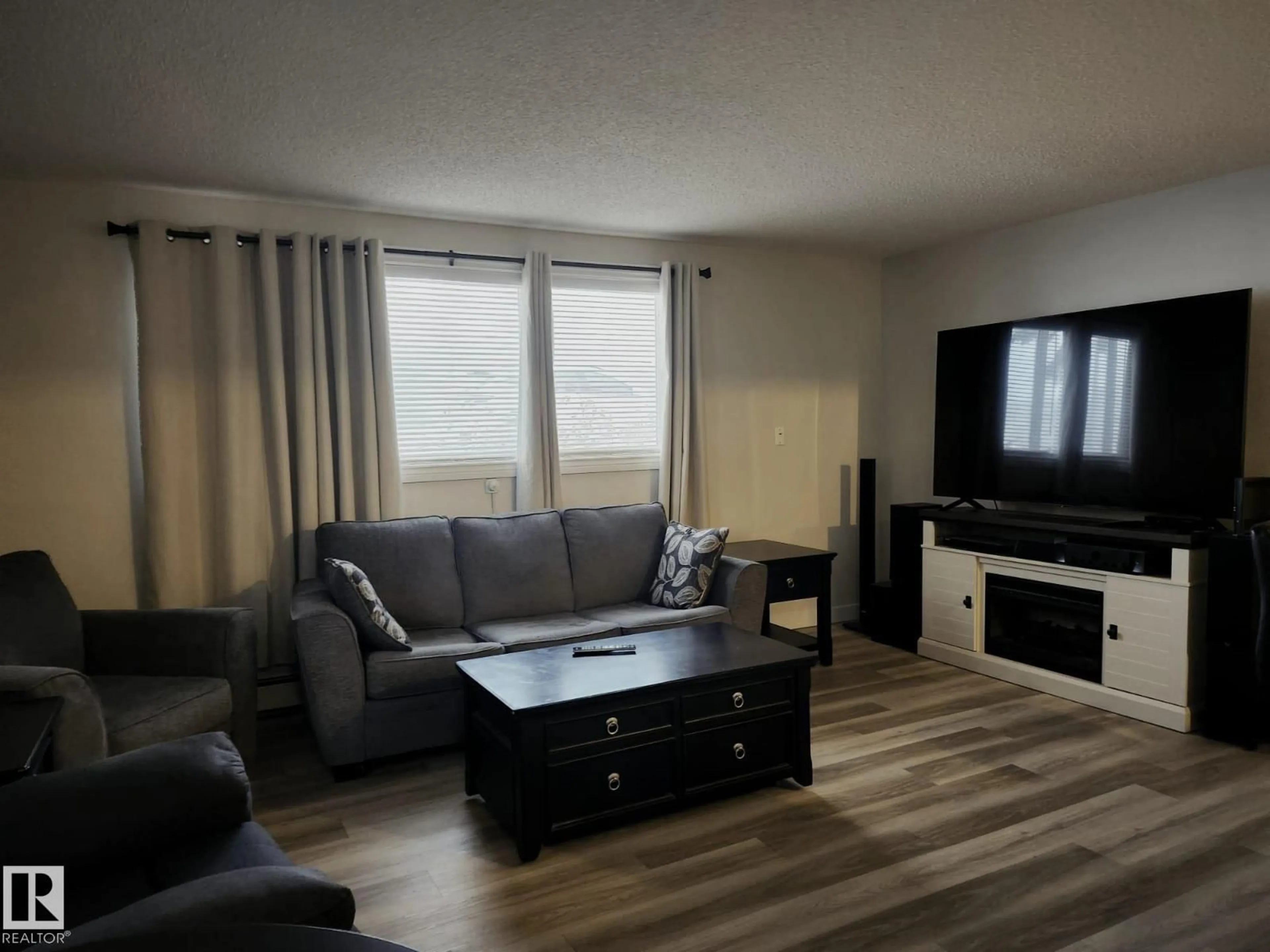 Living room with furniture, wood/laminate floor for #4 - 6120 118 AV, Edmonton Alberta T5W1E8