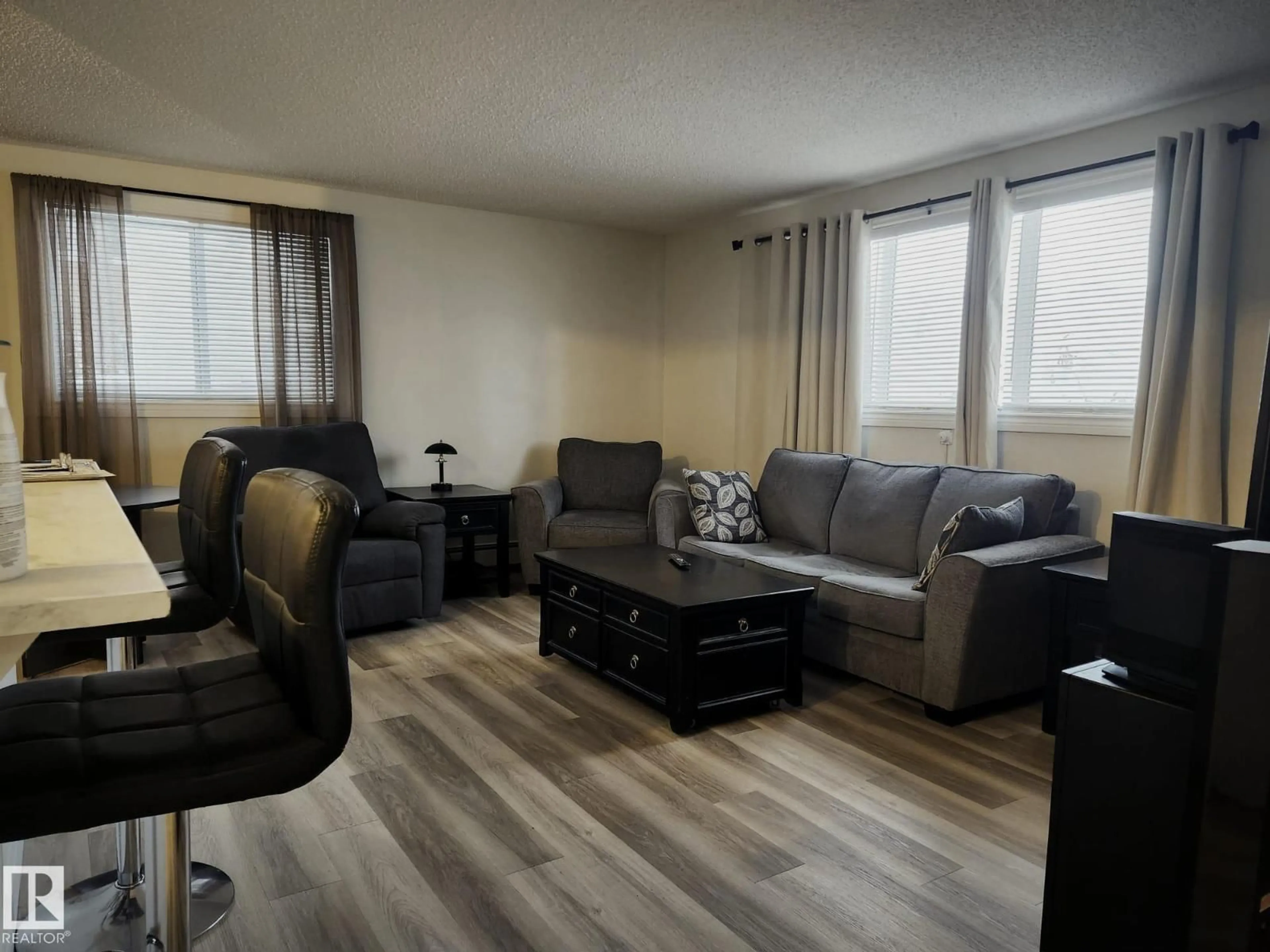 Living room with furniture, wood/laminate floor for #4 - 6120 118 AV, Edmonton Alberta T5W1E8