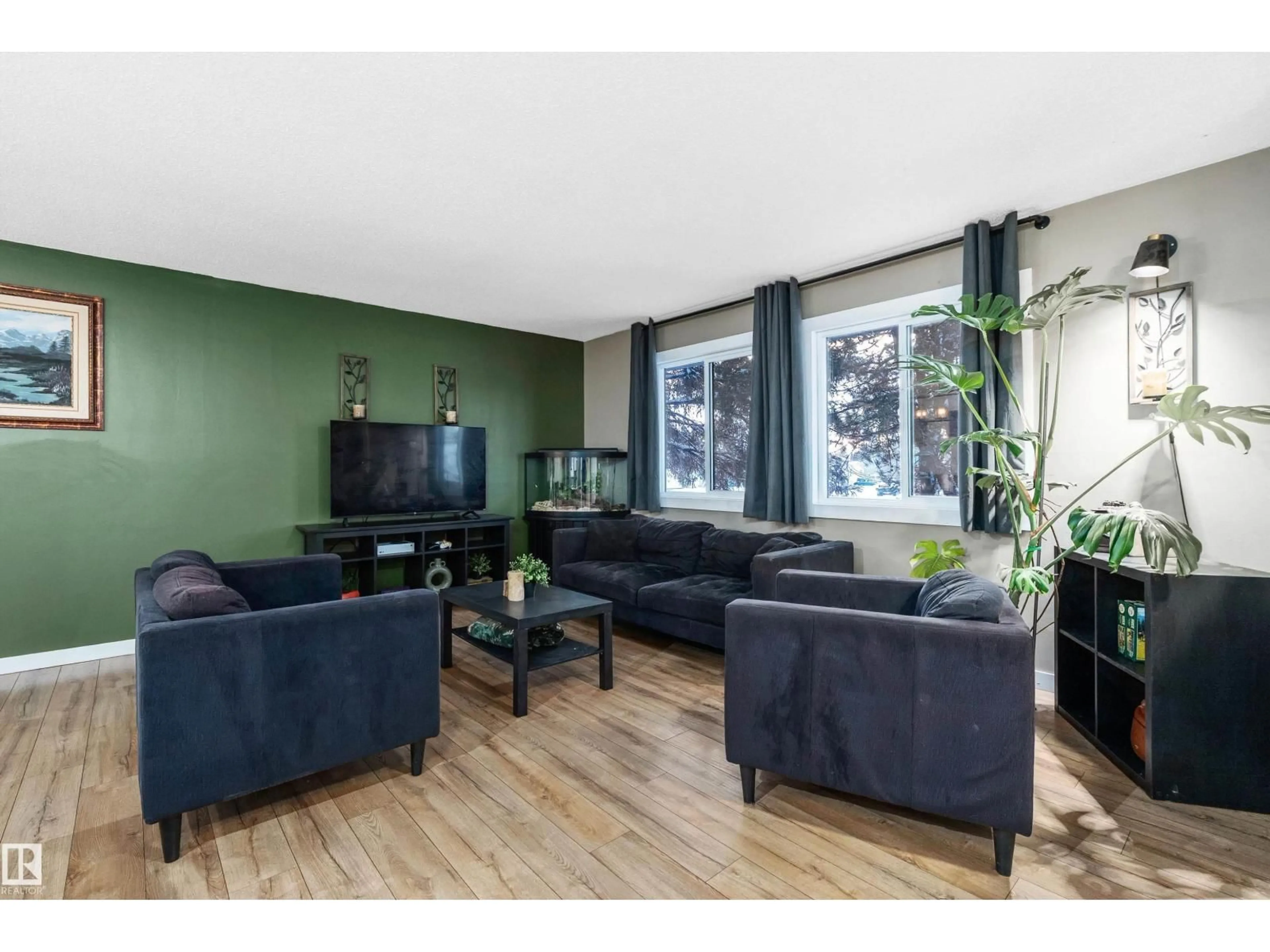 Living room with furniture, wood/laminate floor for 33 WILD HAY DR, Devon Alberta T9G1S5