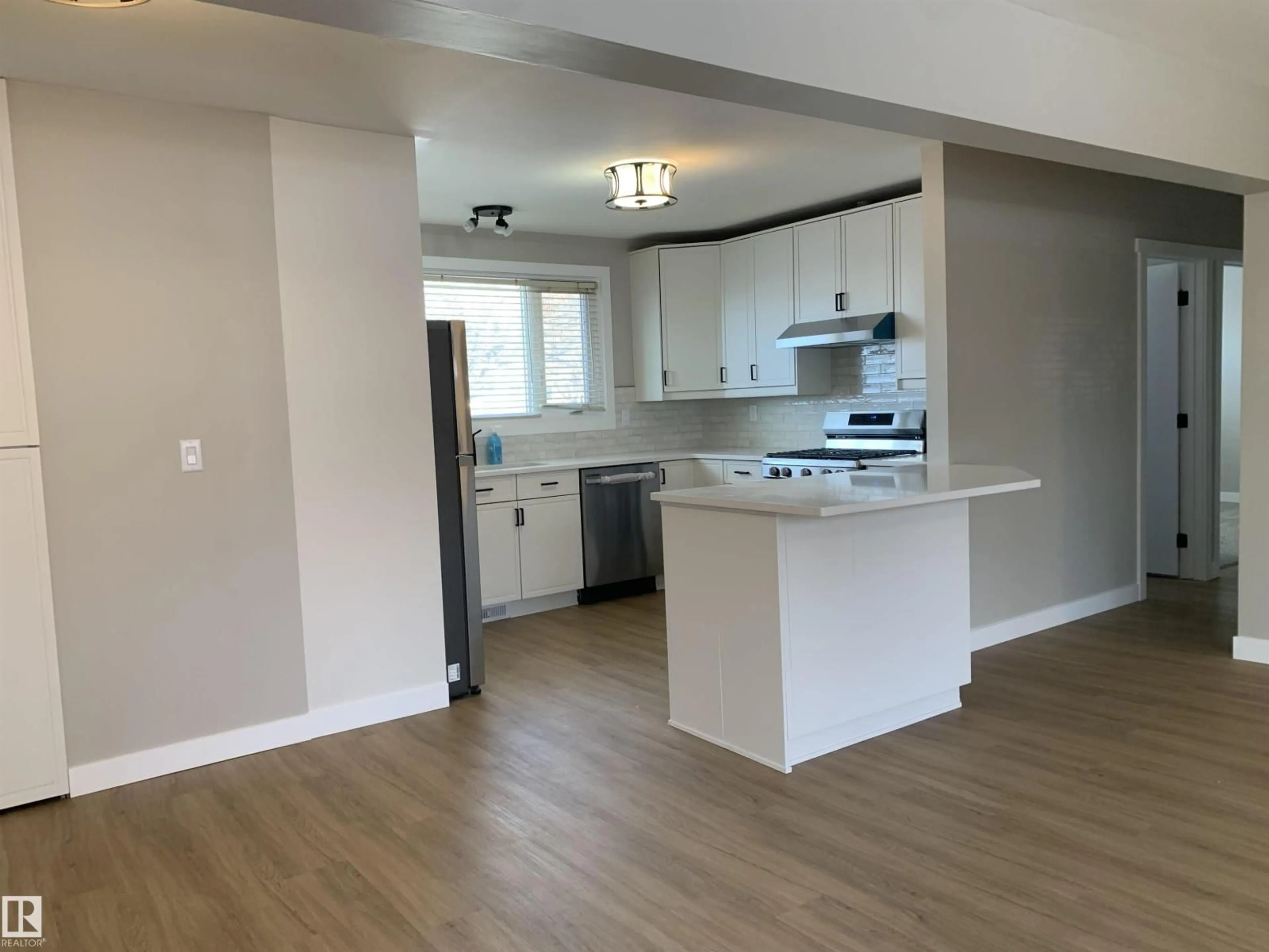 Open concept kitchen, wood/laminate floor for NW - 10816 163 ST, Edmonton Alberta T5P3P6