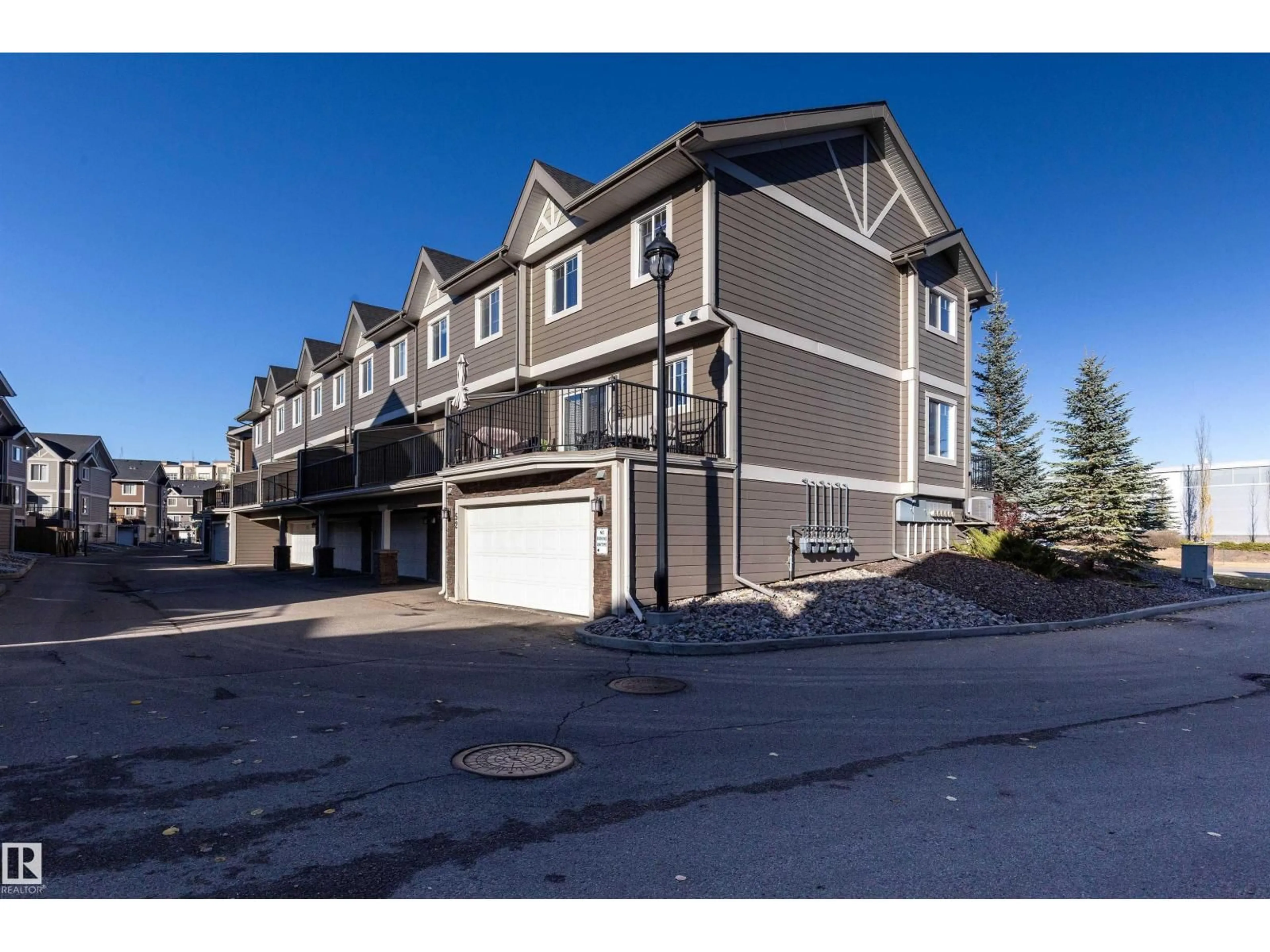 A pic from outside/outdoor area/front of a property/back of a property/a pic from drone, street for 52 - 1150 WINDERMERE WY, Edmonton Alberta T6W2B6