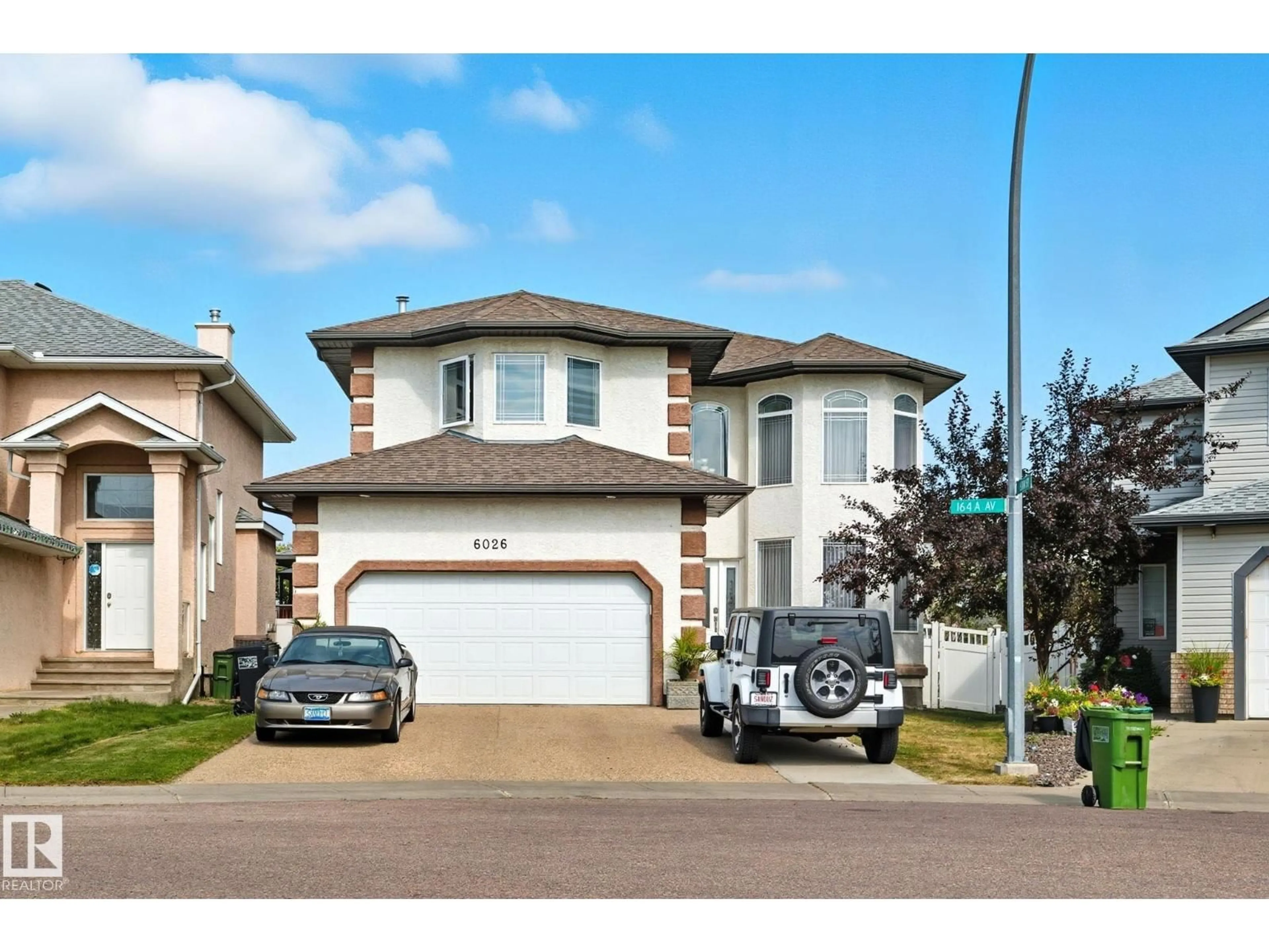 Home with vinyl exterior material, street for 6026 164A AV, Edmonton Alberta T5Y0A7