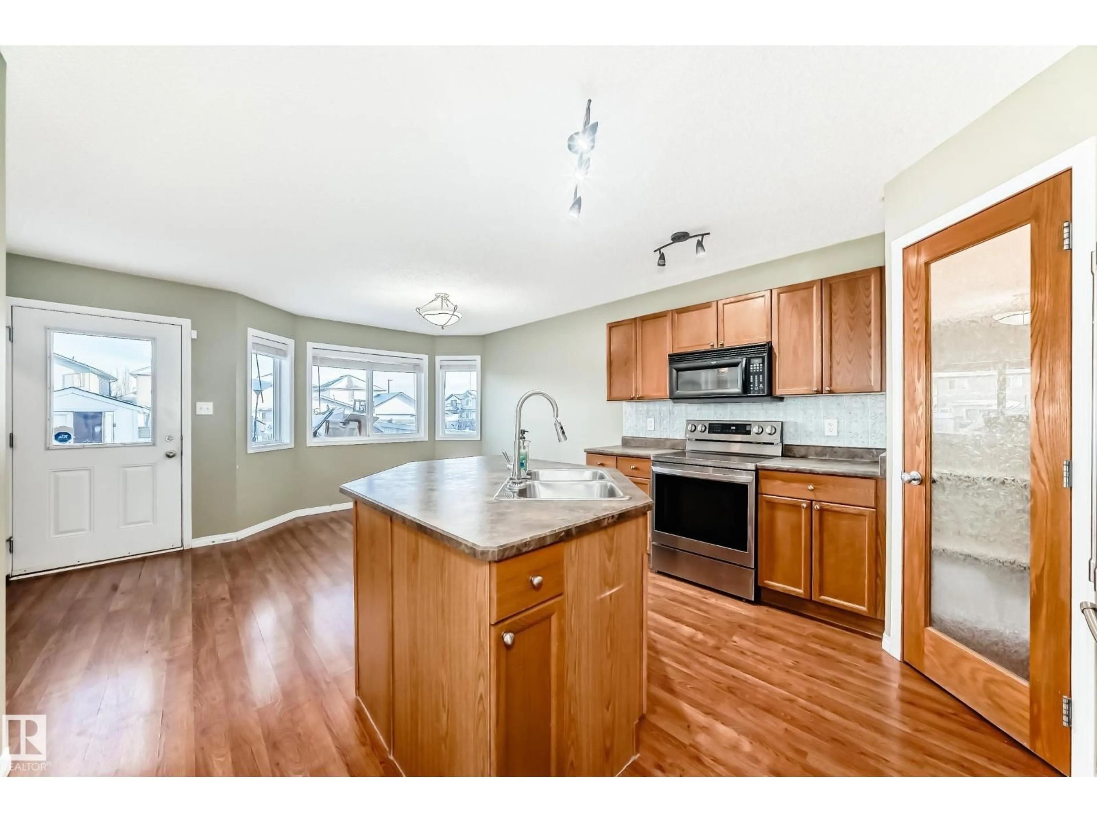 Open concept kitchen, wood/laminate floor for NW - 2805 25 ST, Edmonton Alberta T6T2A3
