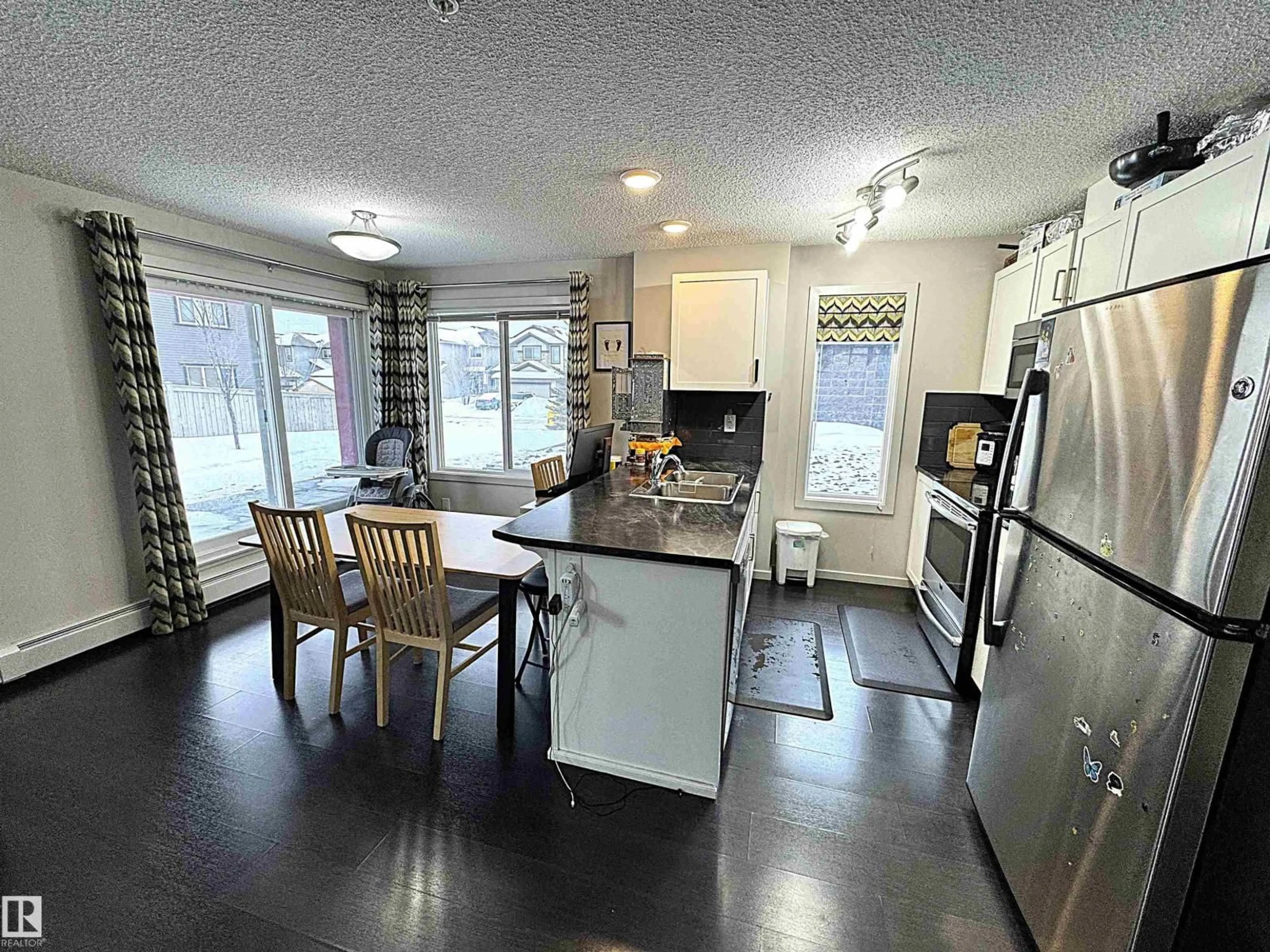 Open concept kitchen, wood/laminate floor for 117 - 5521 7 AV SW, Edmonton Alberta T6X2A8