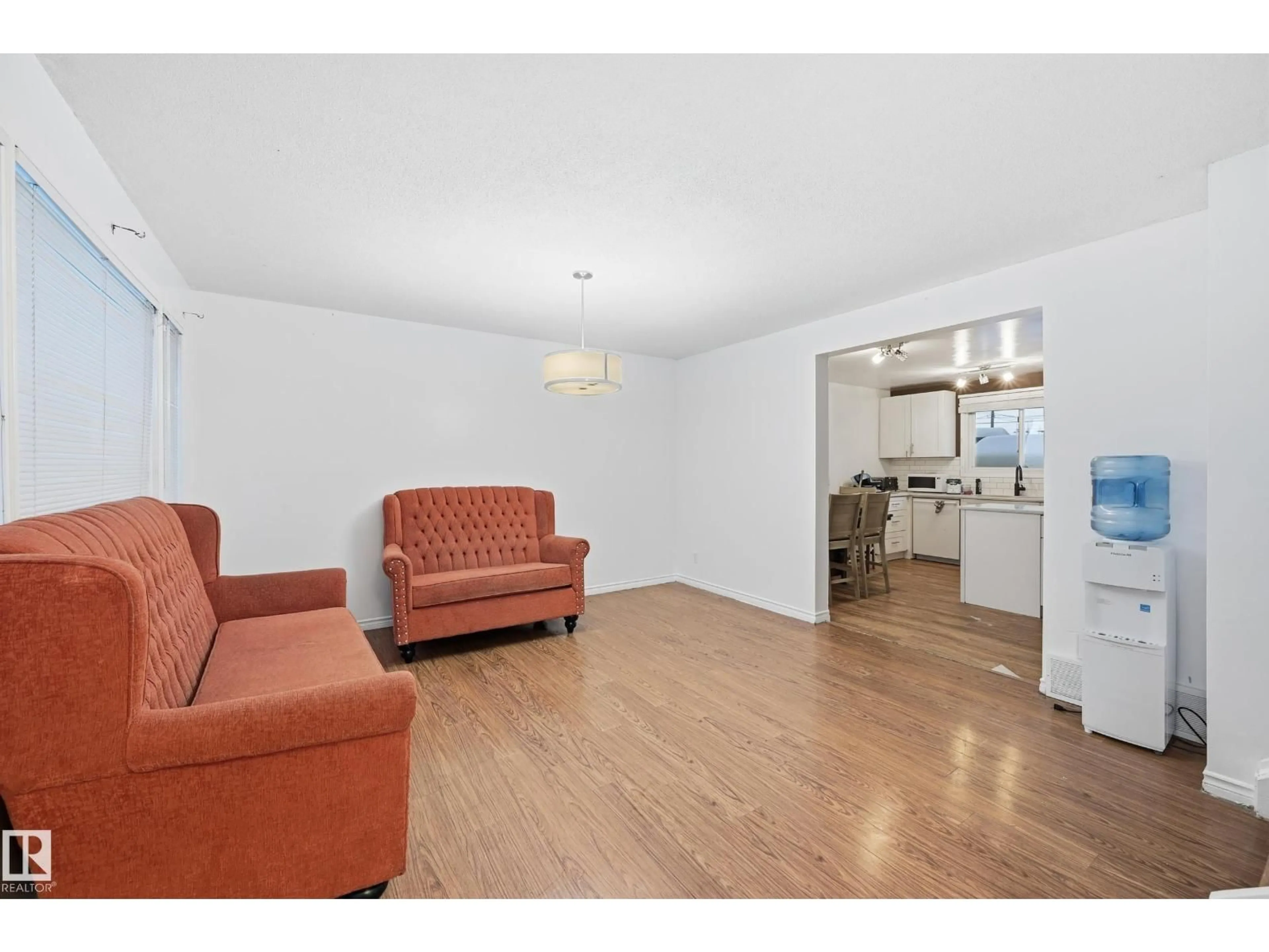 Living room with furniture, wood/laminate floor for 10810 132 AV, Edmonton Alberta T5E0Z6