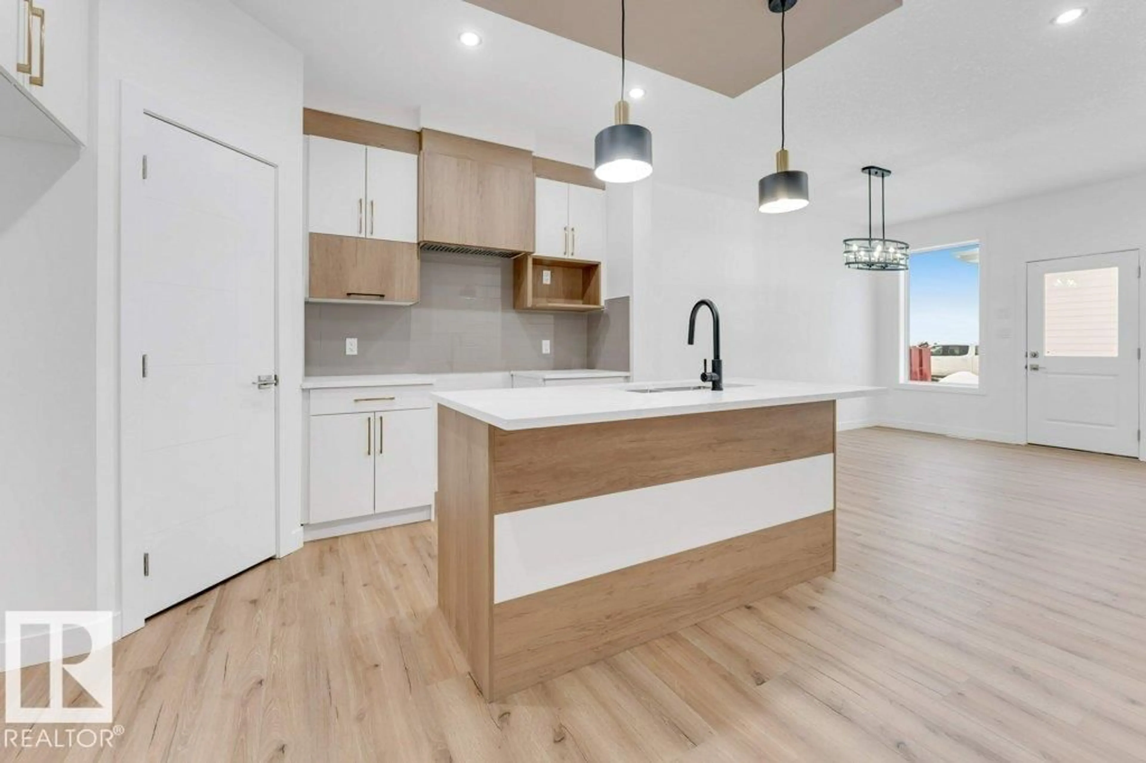 Open concept kitchen, wood/laminate floor for 402 CRYSTAL CREEK LINK, Leduc Alberta T9E1N3