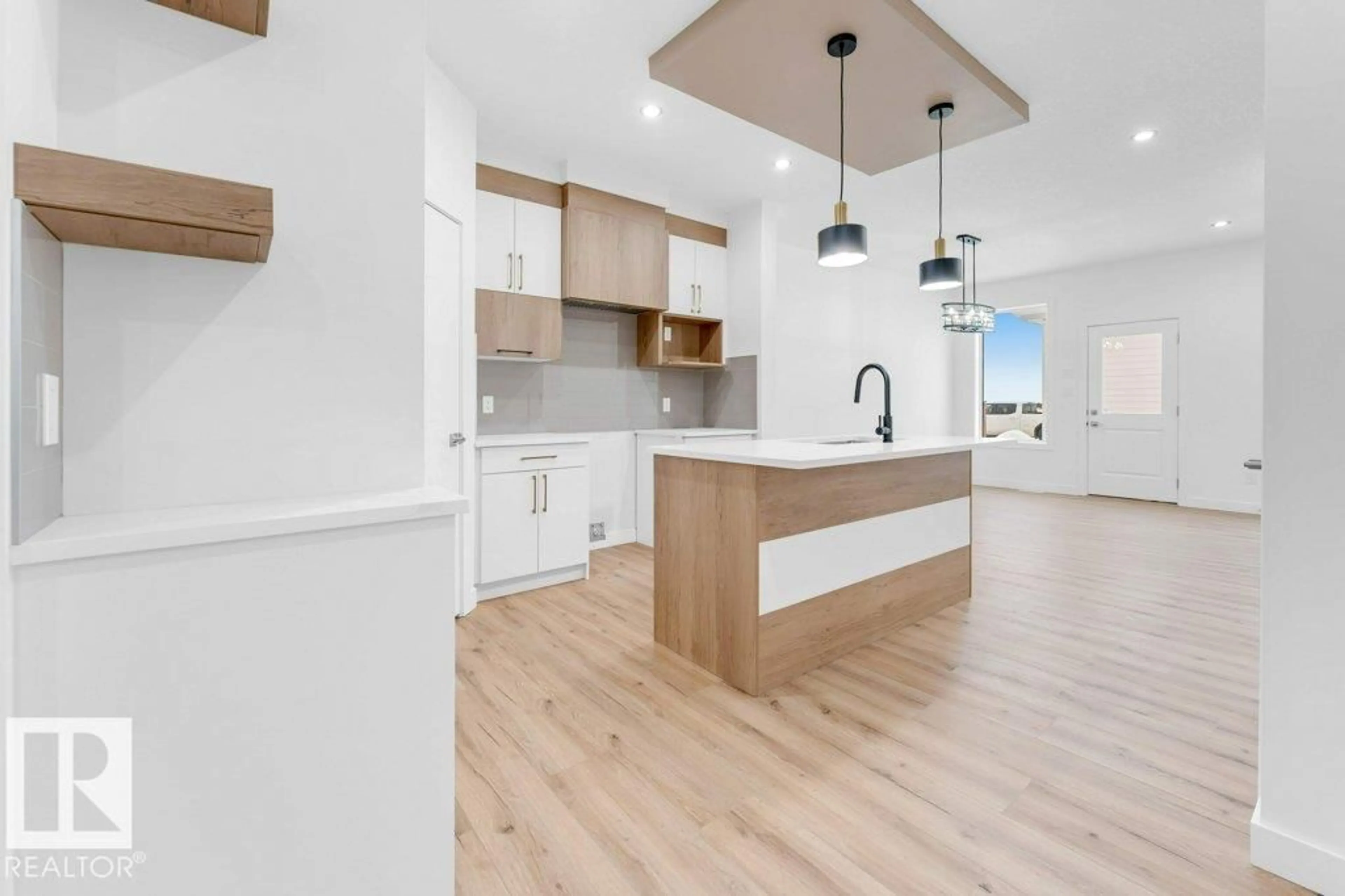 Open concept kitchen, wood/laminate floor for 402 CRYSTAL CREEK LINK, Leduc Alberta T9E1N3