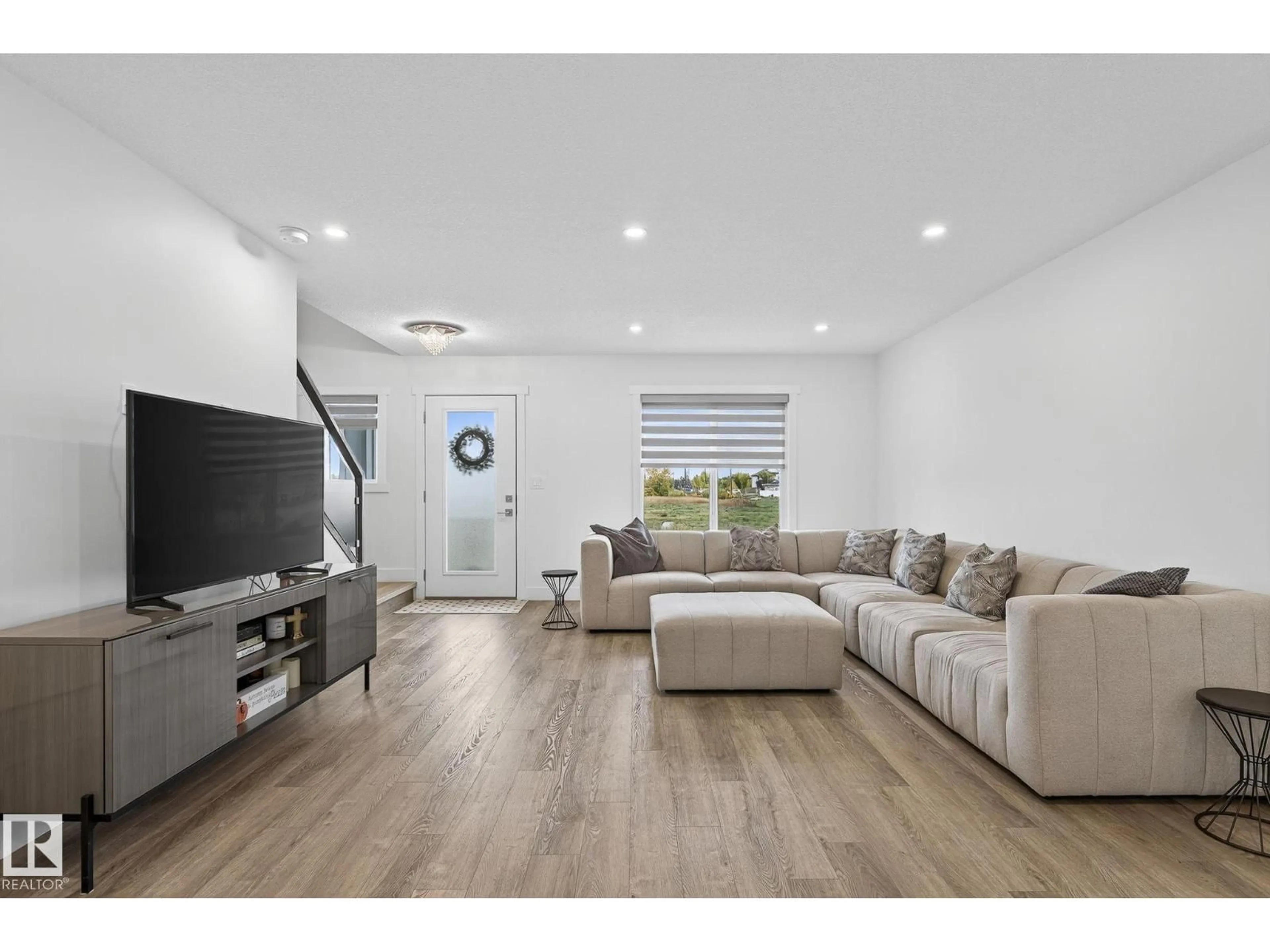 Living room with furniture, wood/laminate floor for #16 - 9250 156 AV, Edmonton Alberta T5Z3N7