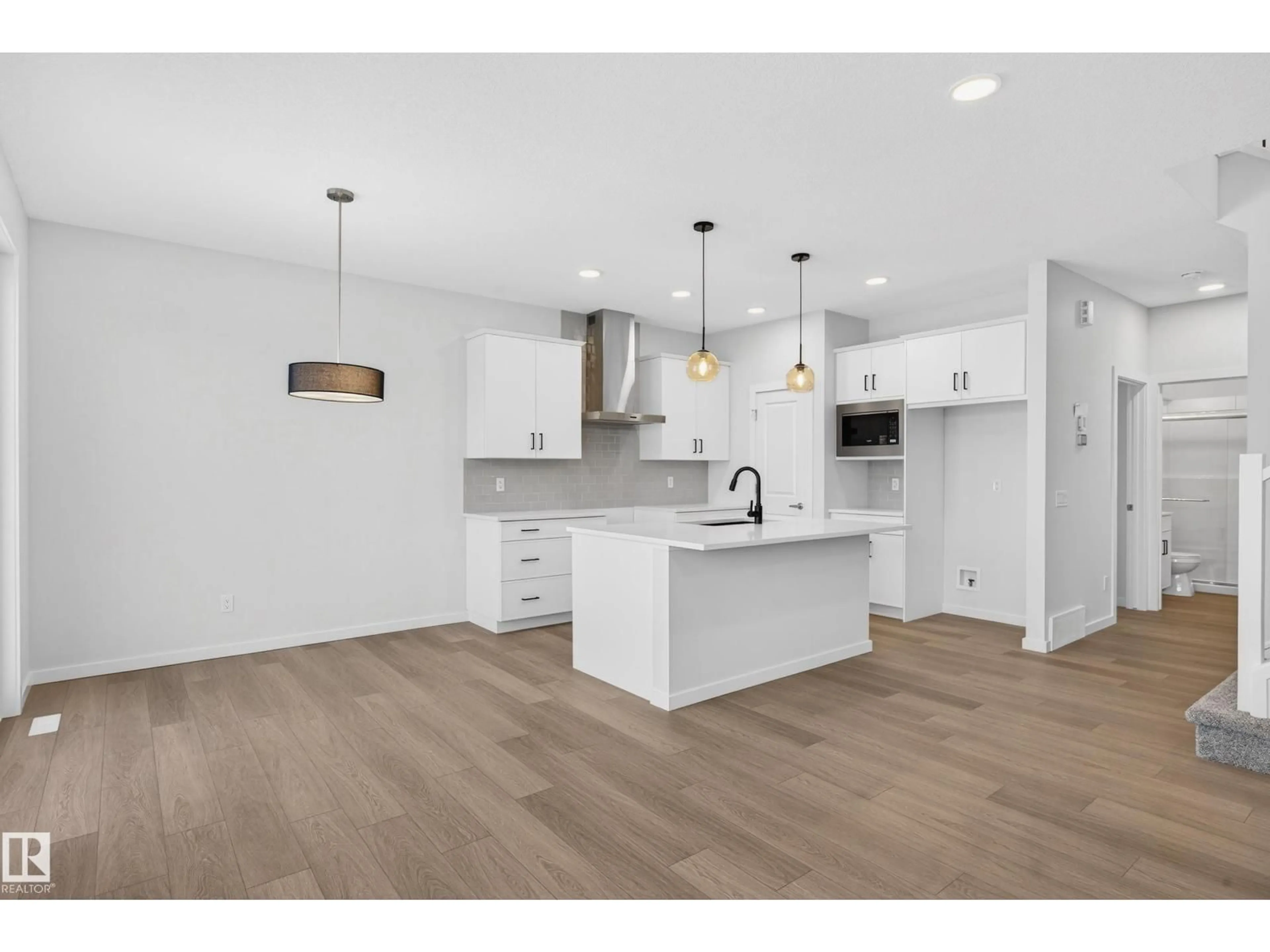 Open concept kitchen, wood/laminate floor for NW - 2217 193A ST, Edmonton Alberta T6M3B7
