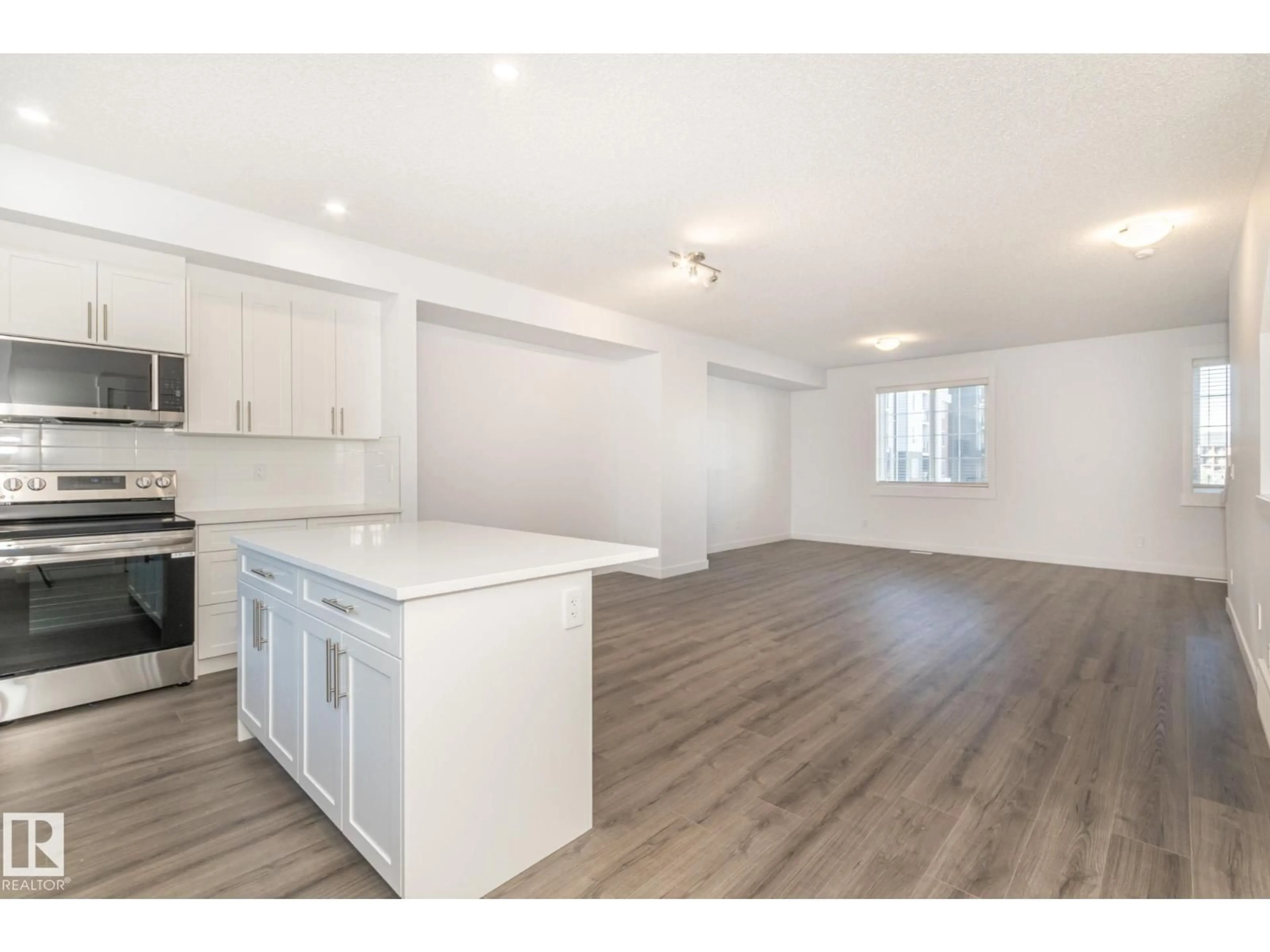 Open concept kitchen, wood/laminate floor for #14 - 735 ALLARD BV, Edmonton Alberta T6W1A8