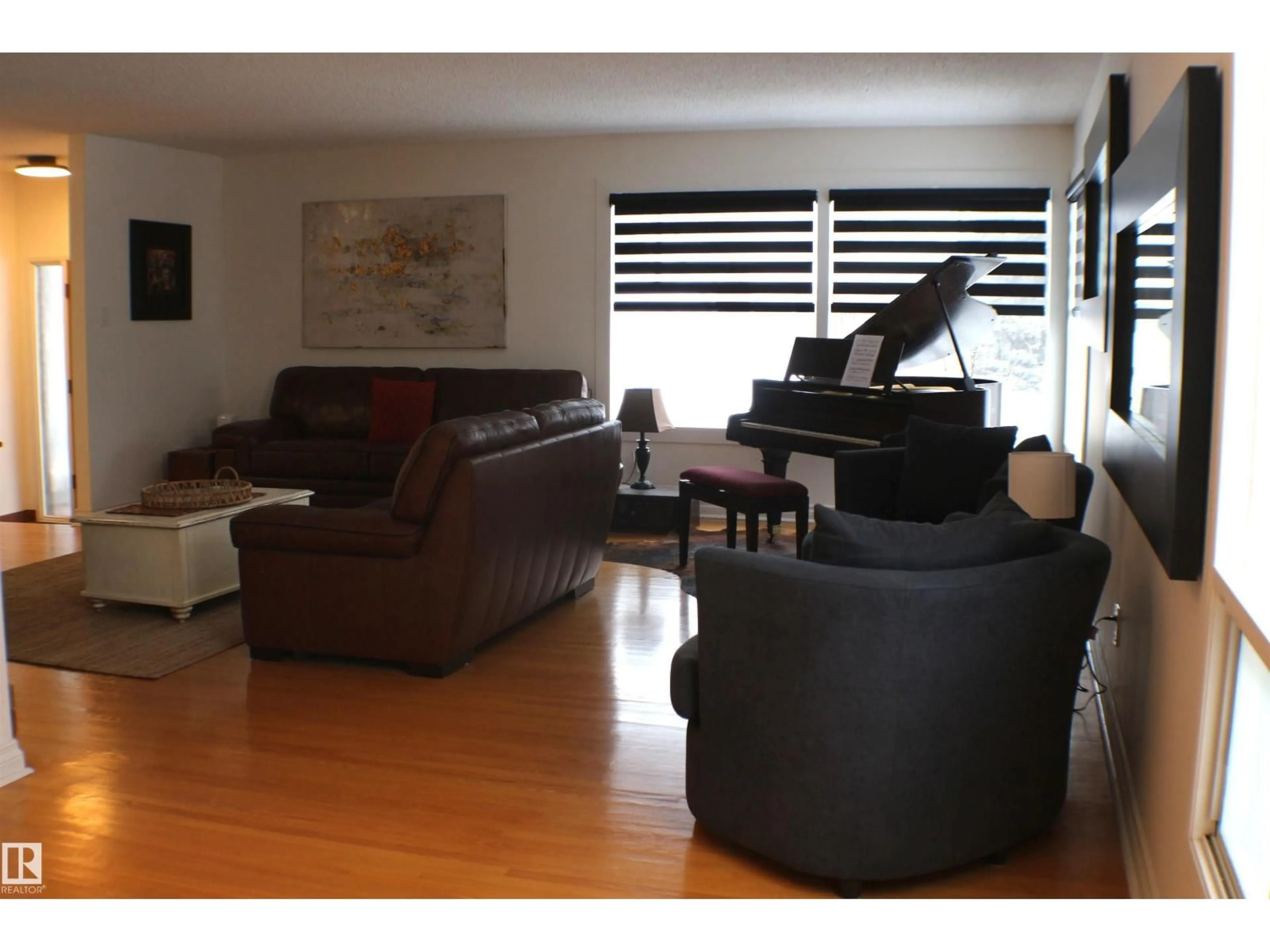 Living room with furniture, wood/laminate floor for 4403 107A AV, Edmonton Alberta T6A1M7