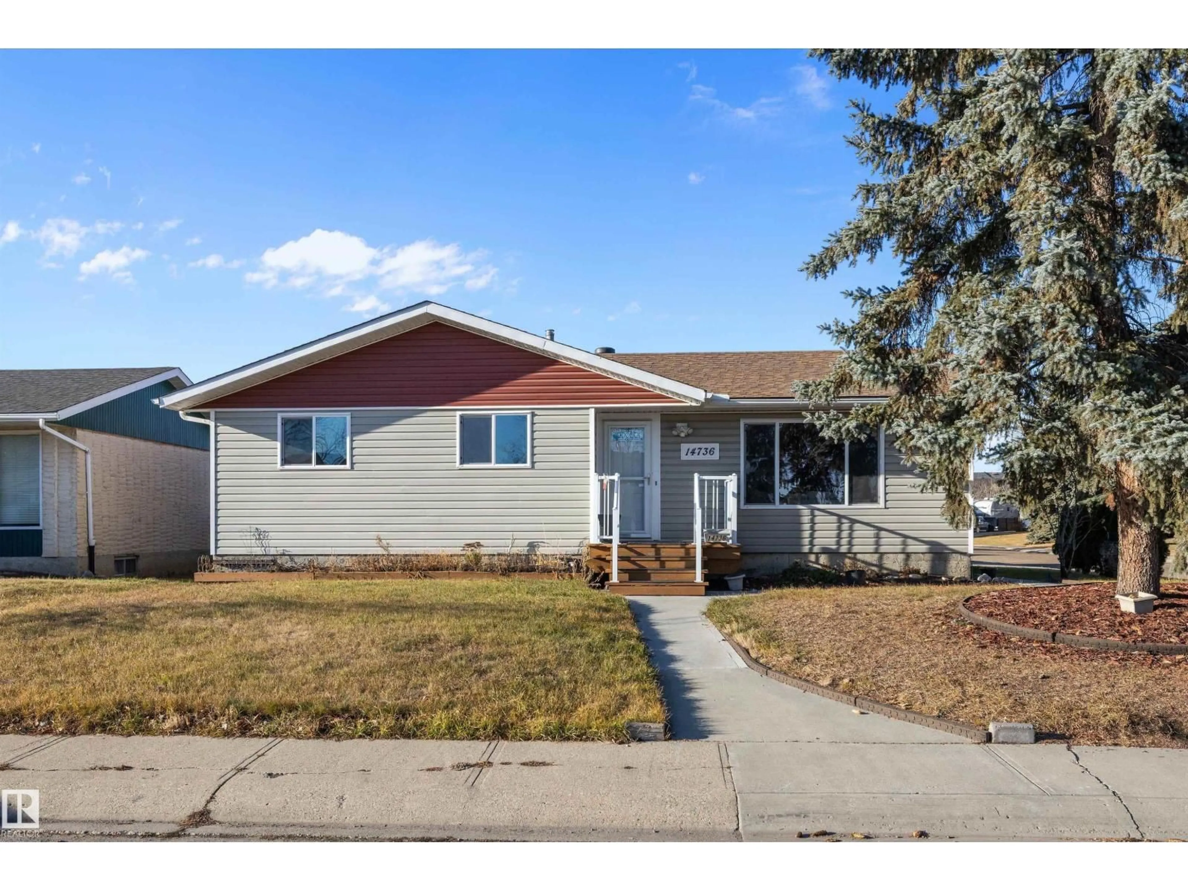 Home with vinyl exterior material, street for 14736 122 ST, Edmonton Alberta T5X1V9