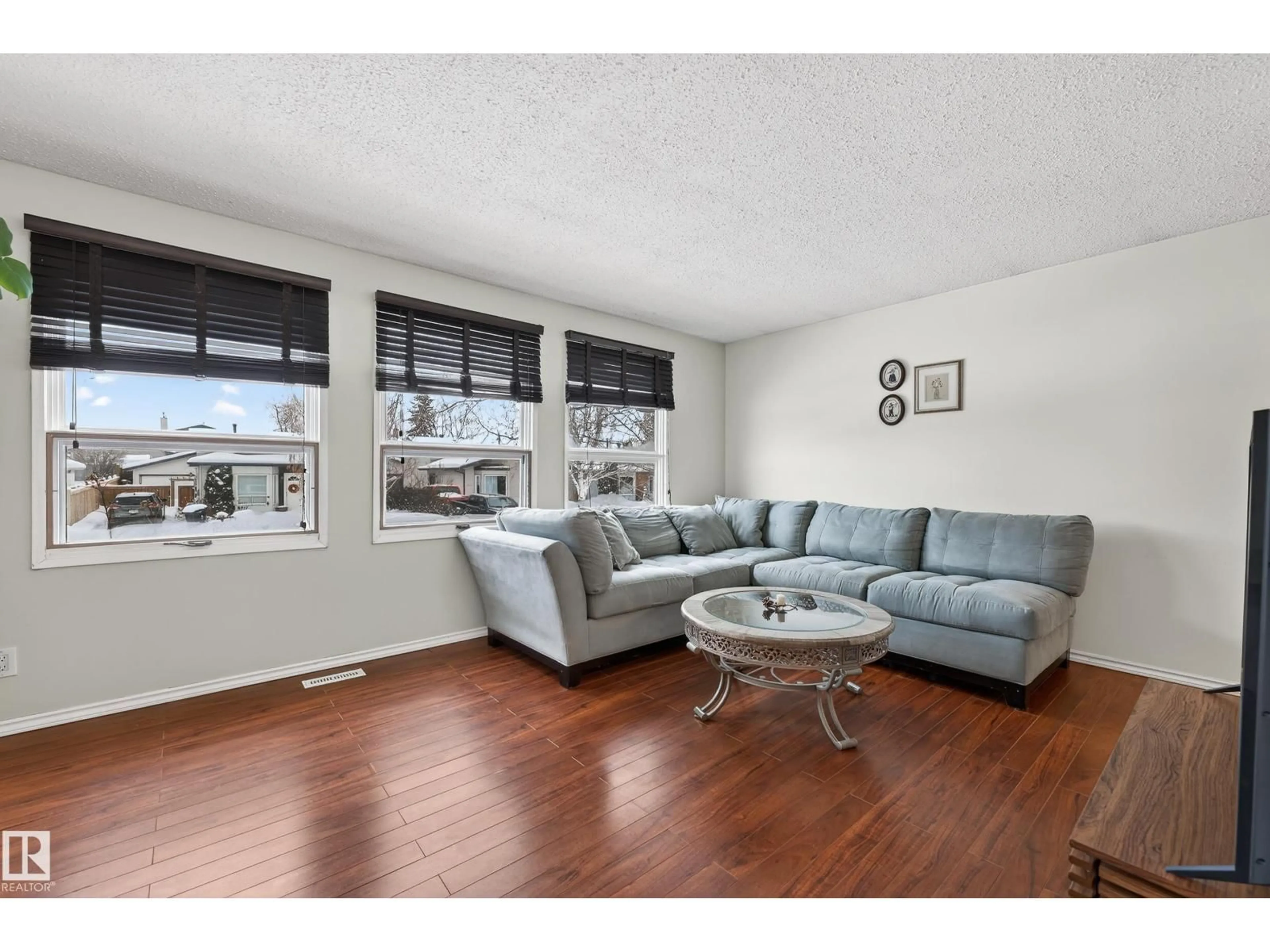 Living room with furniture, wood/laminate floor for 8014 92A AV, Fort Saskatchewan Alberta T8L3M8