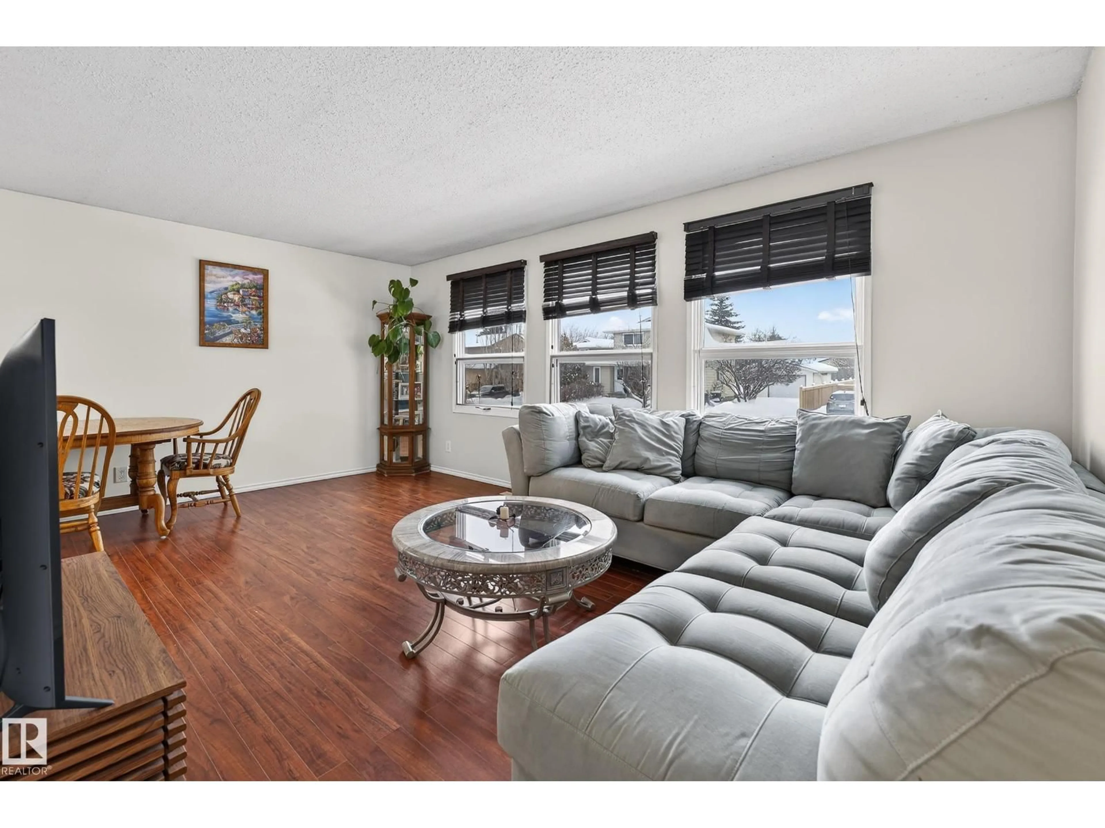 Living room with furniture, wood/laminate floor for 8014 92A AV, Fort Saskatchewan Alberta T8L3M8