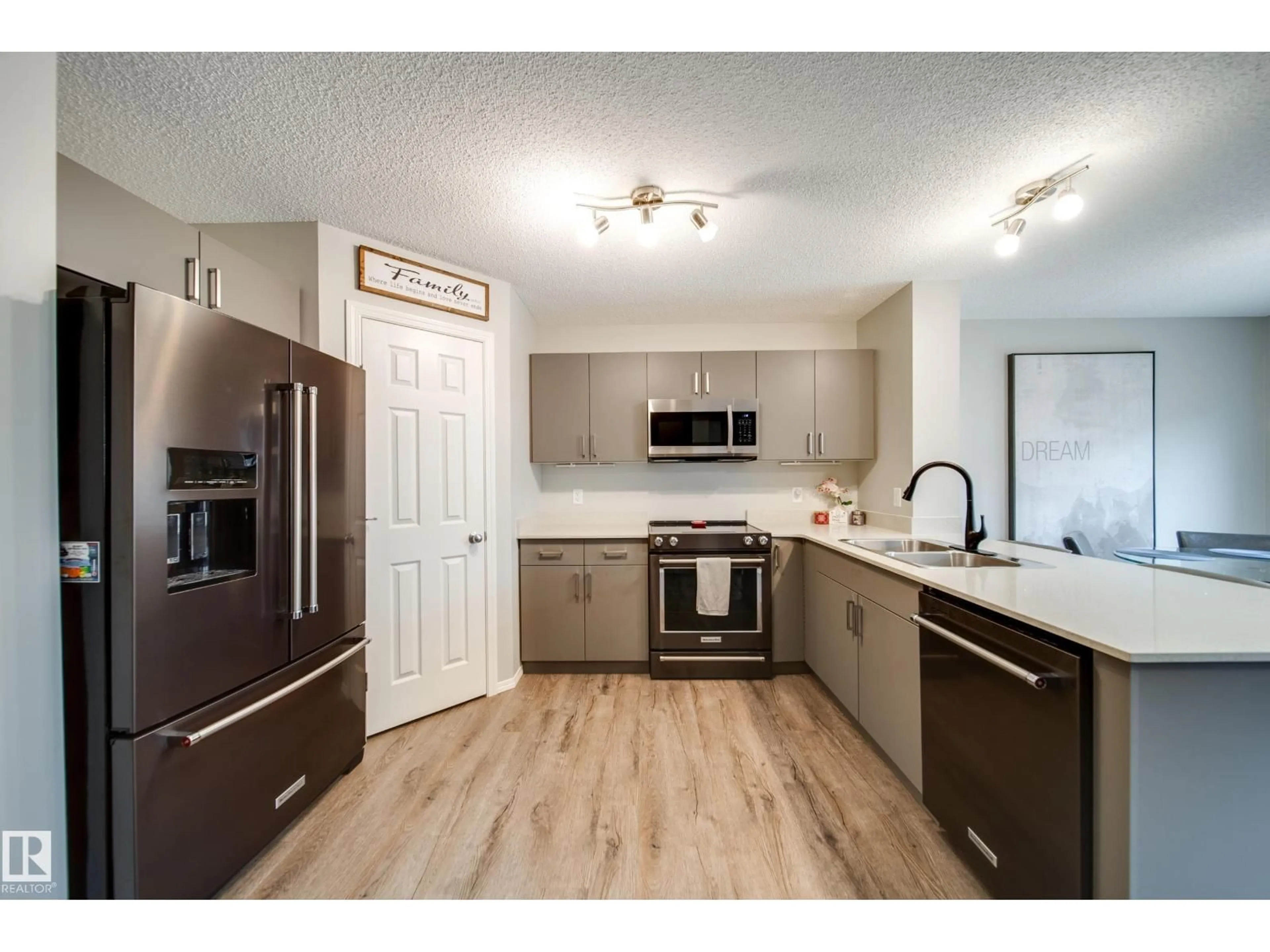 Open concept kitchen, wood/laminate floor for SW - 9040 COOPER LI, Edmonton Alberta T6W4A4