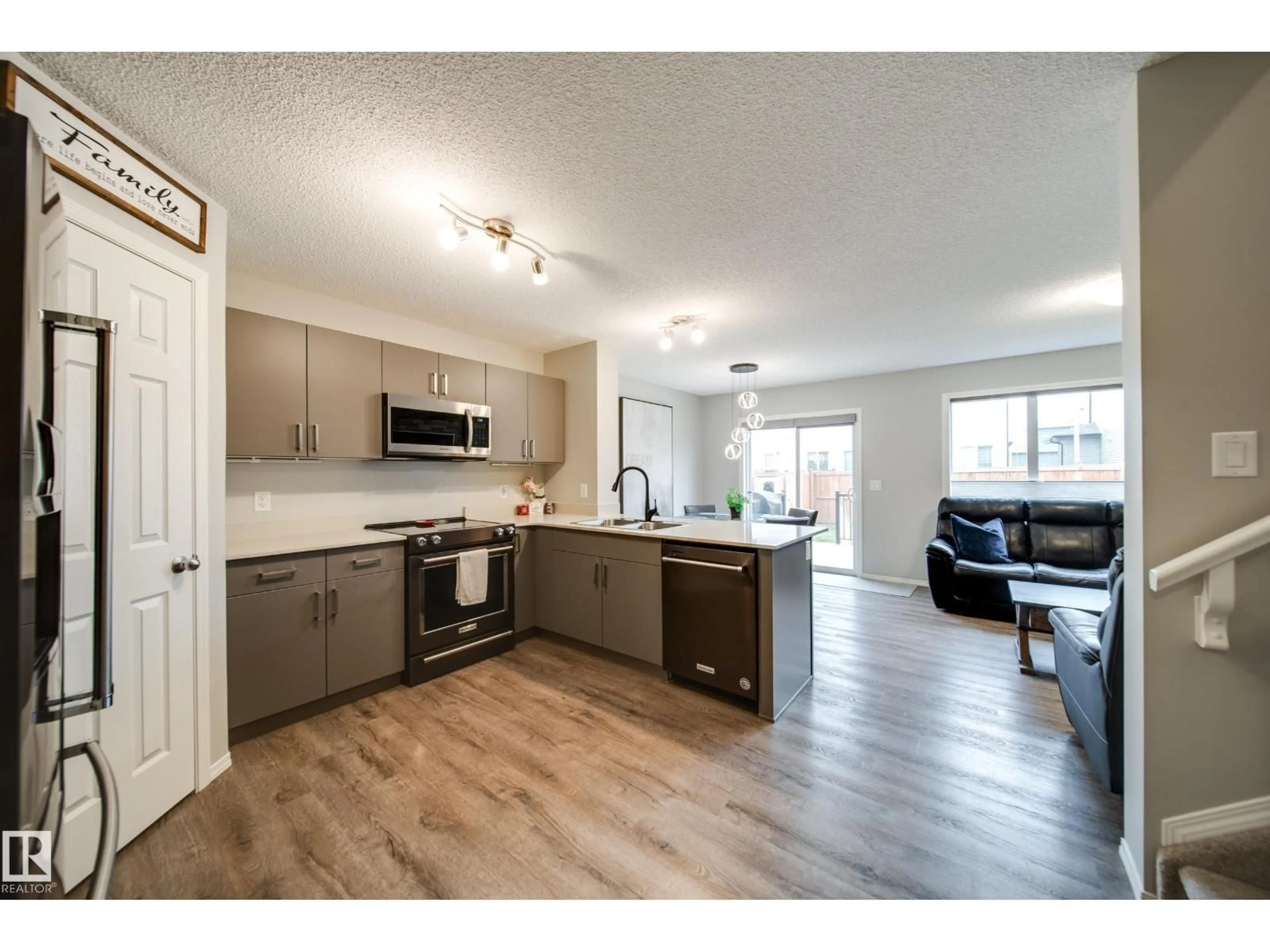 Open concept kitchen, wood/laminate floor for SW - 9040 COOPER LI, Edmonton Alberta T6W4A4