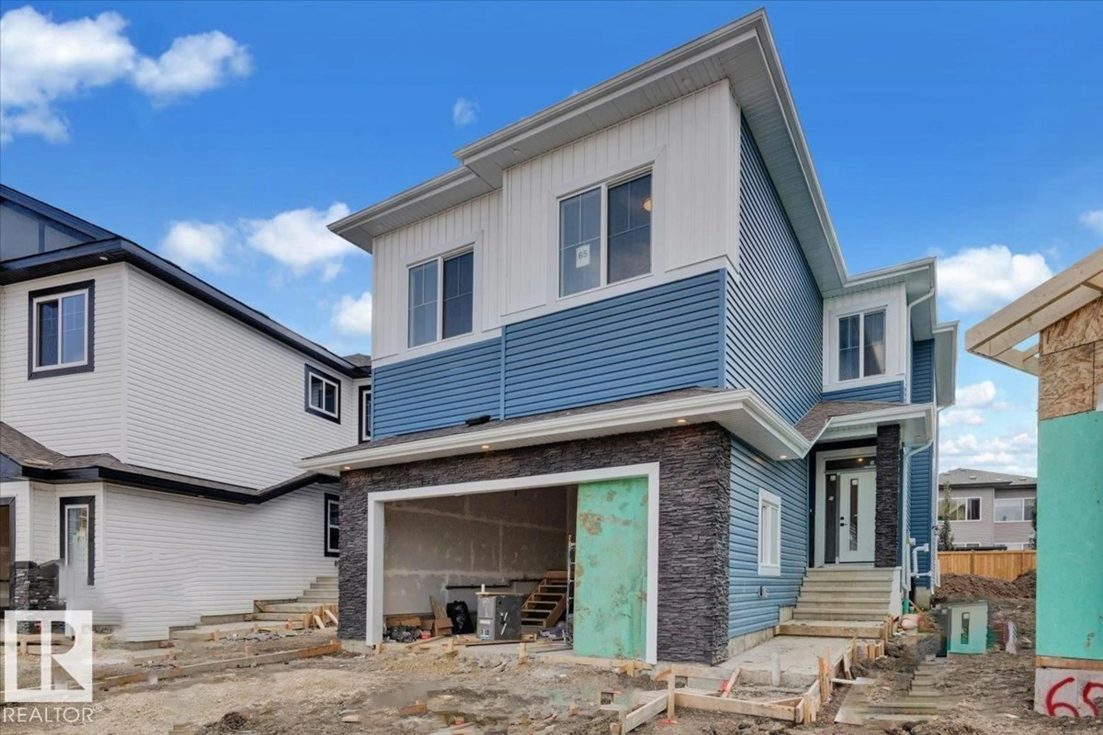 Home with vinyl exterior material, street for 65 BLACKBIRD BEND, Fort Saskatchewan Alberta T8L0G6