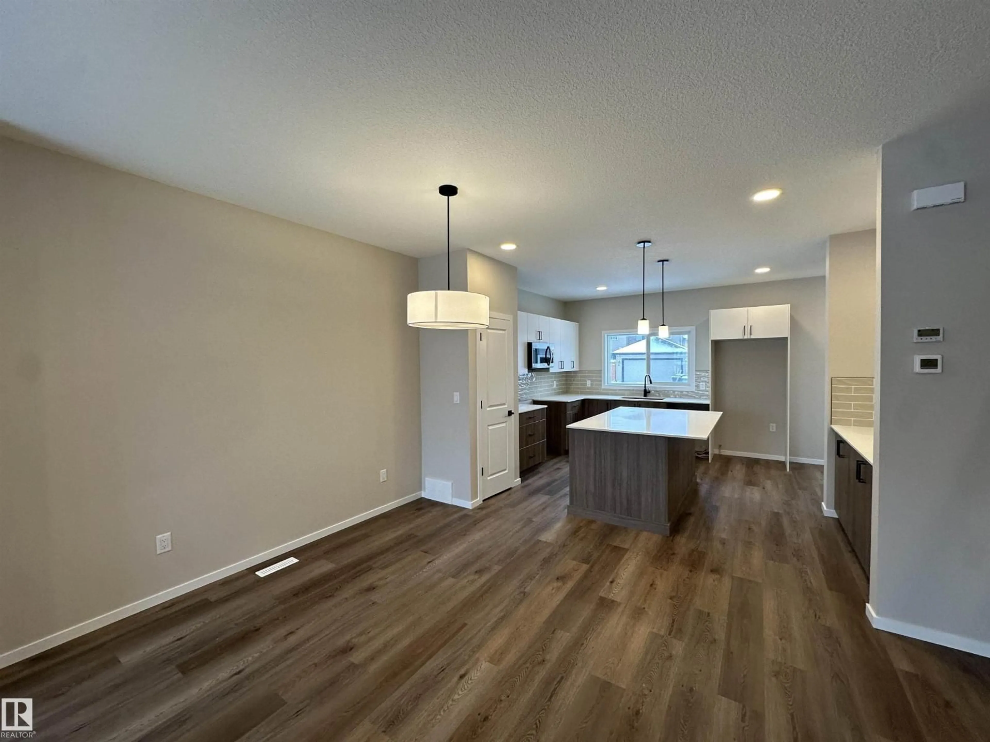 Open concept kitchen, wood/laminate floor for 55 SERENO LN, Fort Saskatchewan Alberta T8L0Z9