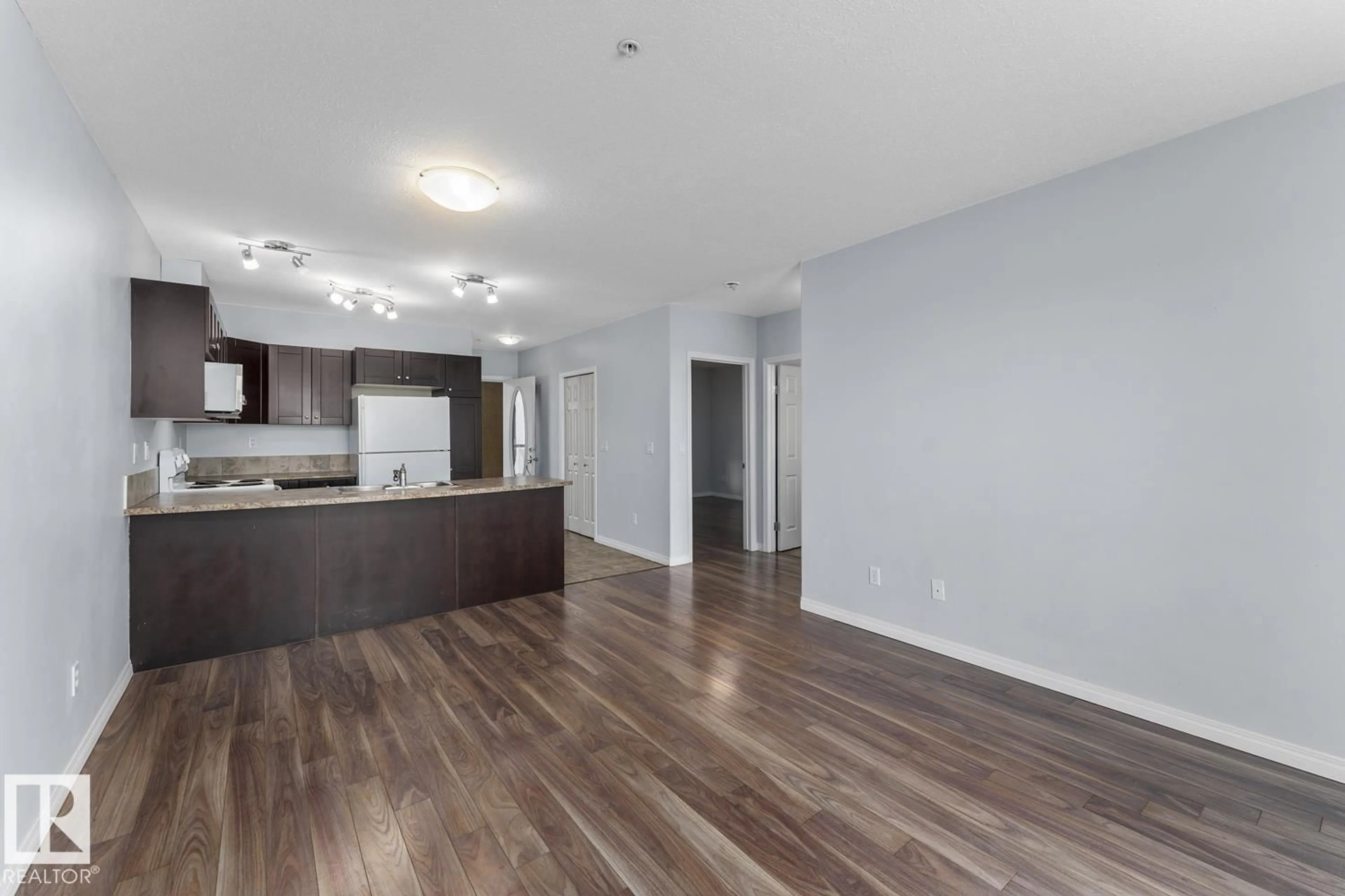 Open concept kitchen, wood/laminate floor for #208 - 802 12 ST, Cold Lake Alberta T9M0A7