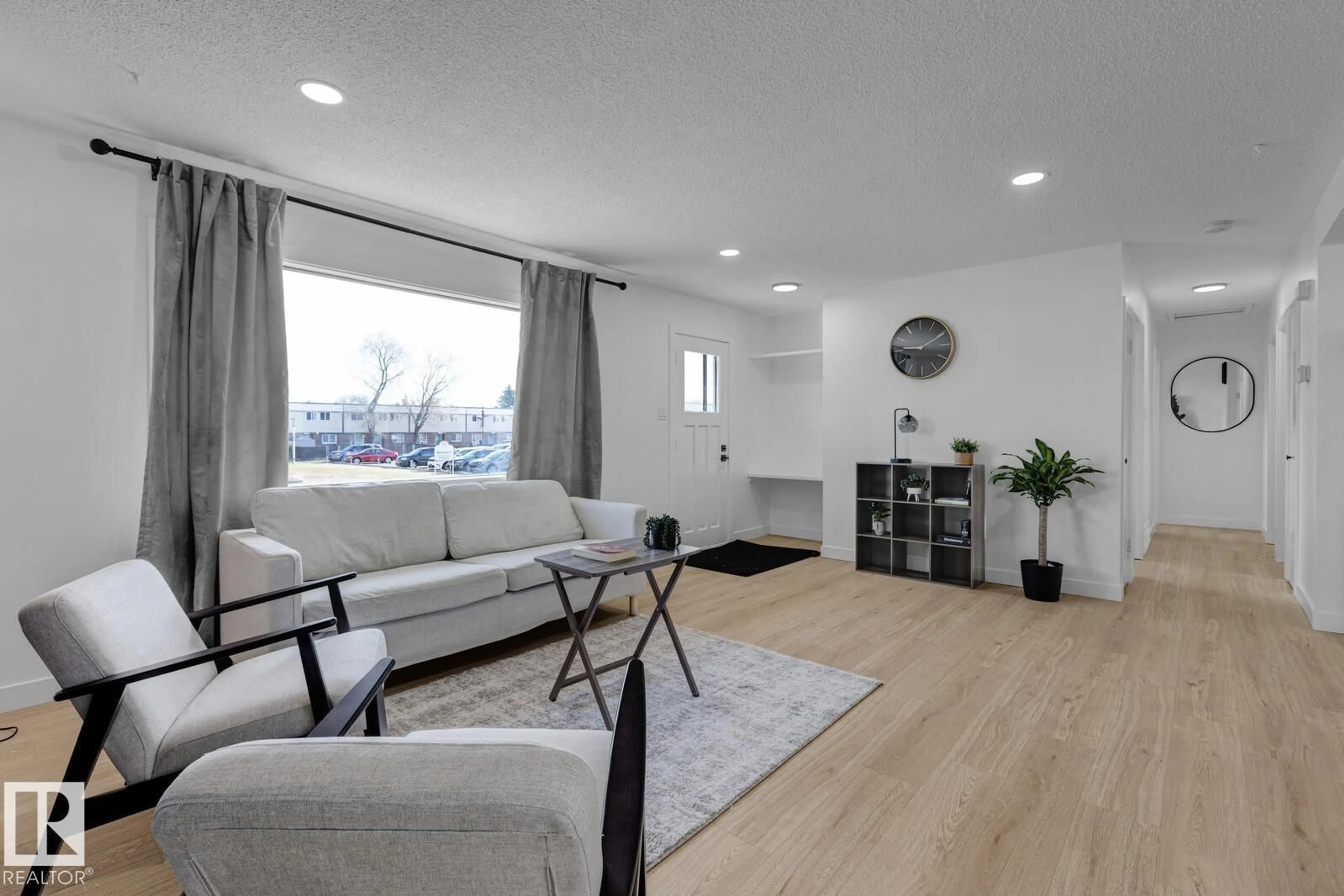 Living room with furniture, wood/laminate floor for 5803 136 AV, Edmonton Alberta T5A0N4