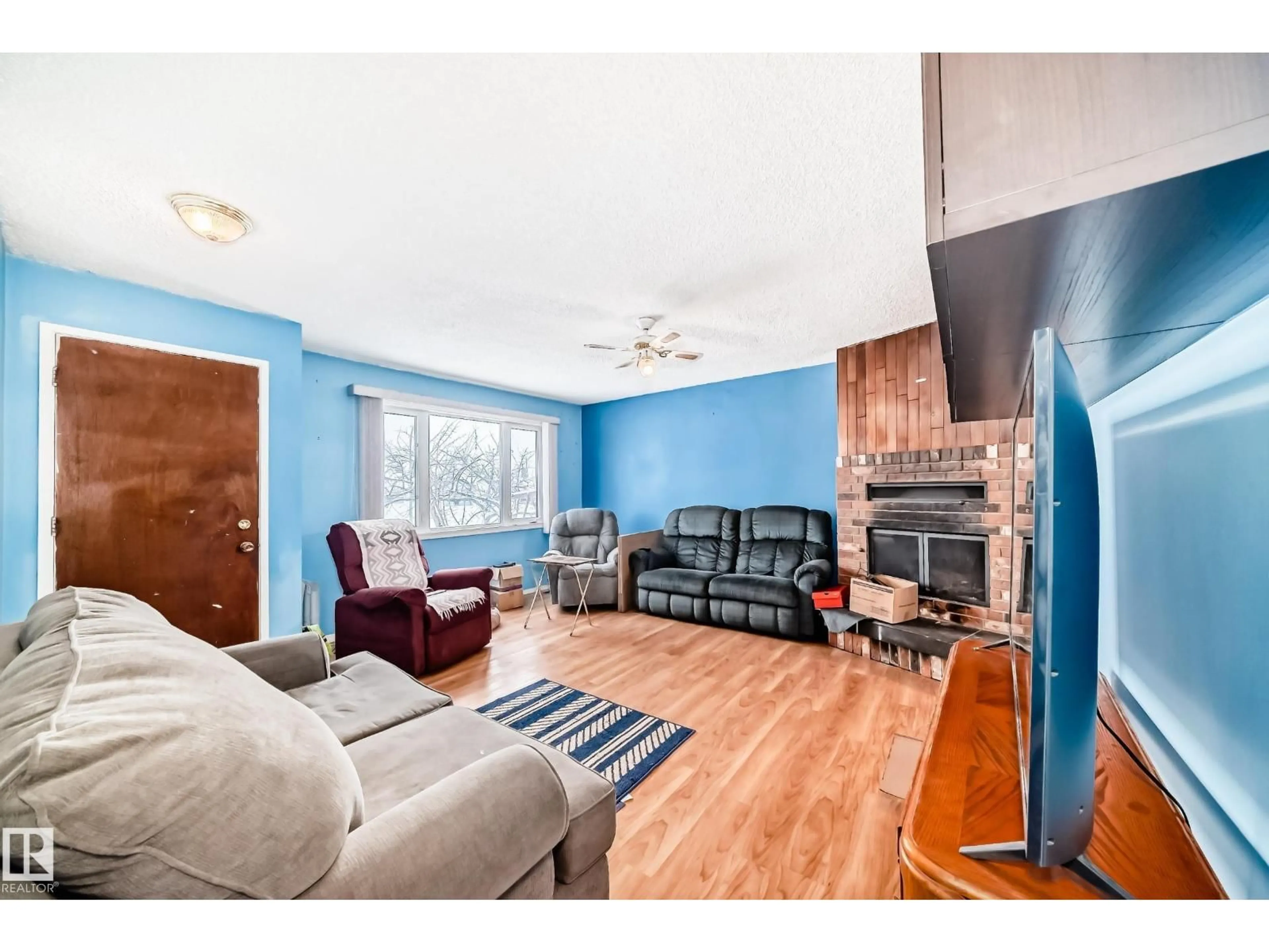 Living room with furniture, wood/laminate floor for 13444 61 ST, Edmonton Alberta T5A0T5