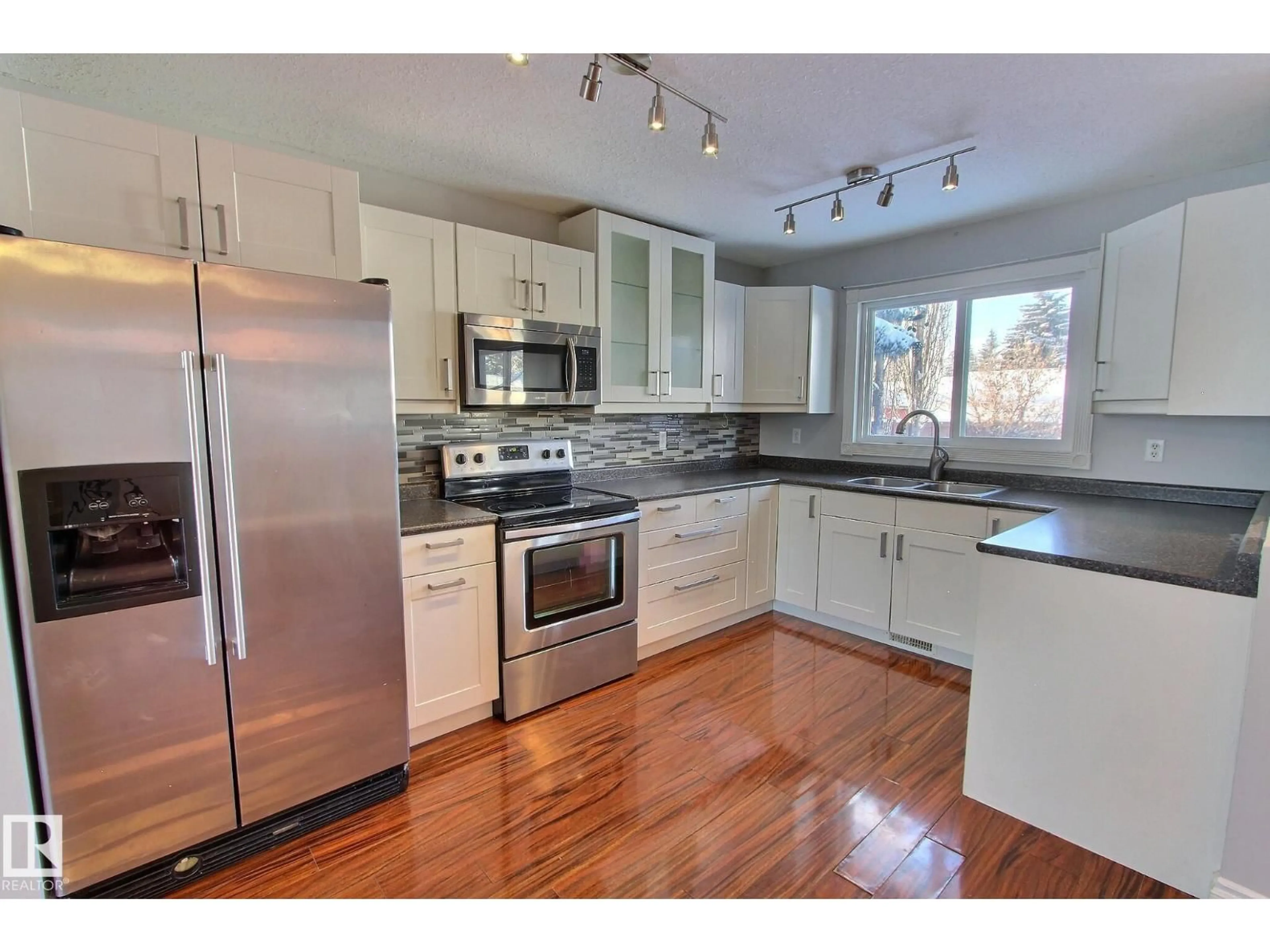 Open concept kitchen, wood/laminate floor for 30 ARLINGTON ST, Spruce Grove Alberta T7X2E7