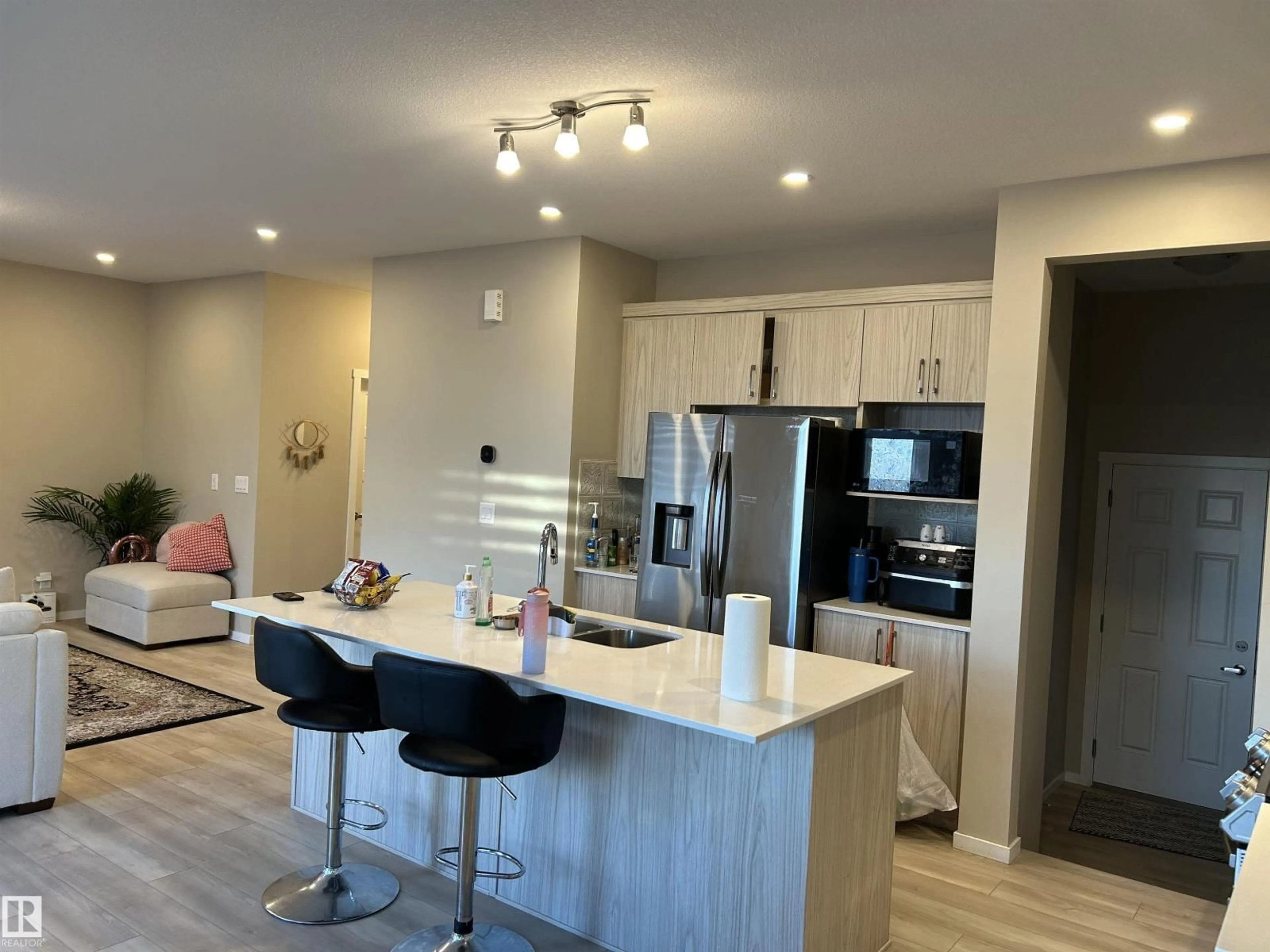 Open concept kitchen, wood/laminate floor for 1019 OLD MAN CREEK BV, Sherwood Park Alberta T8H3A2