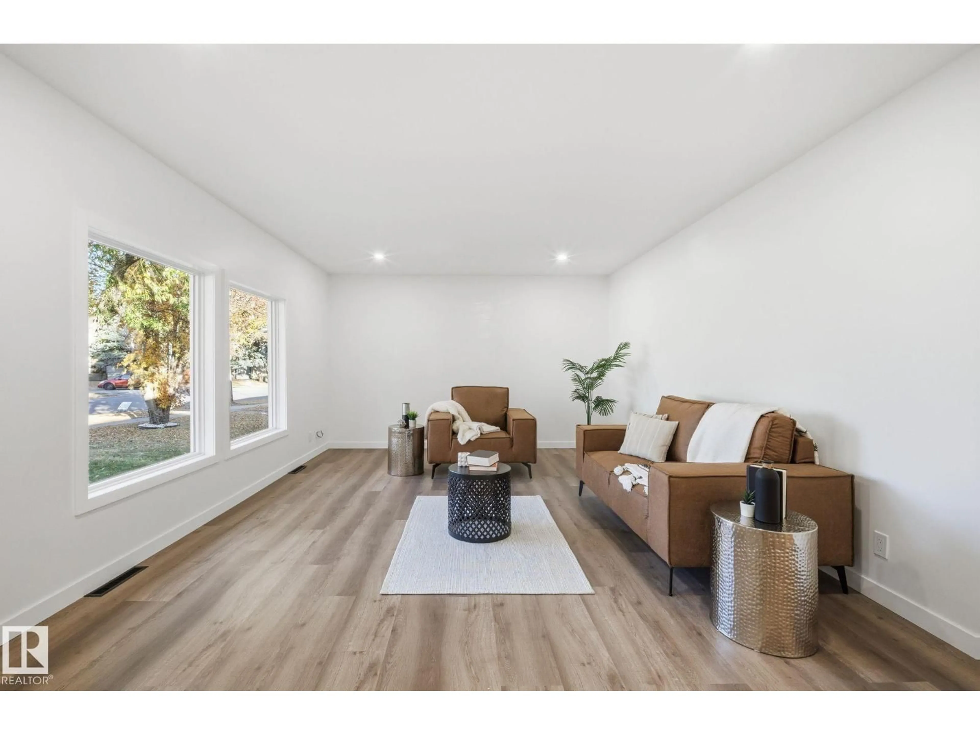 Living room with furniture, wood/laminate floor for 13507 124 AV, Edmonton Alberta T5L3A7