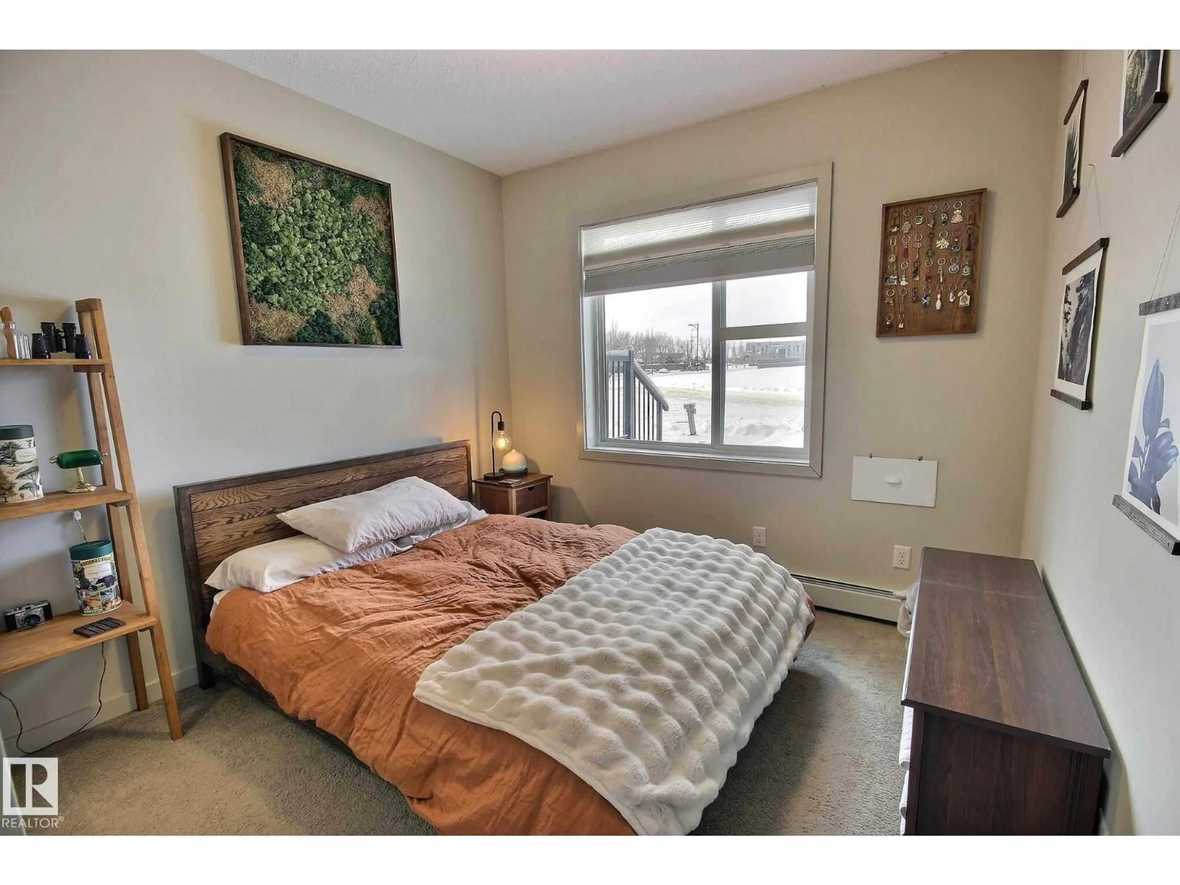 Bedroom with bed, wood/laminate floor for #104 - 320 AMBLESIDE LINK, Edmonton Alberta T6W2Z9