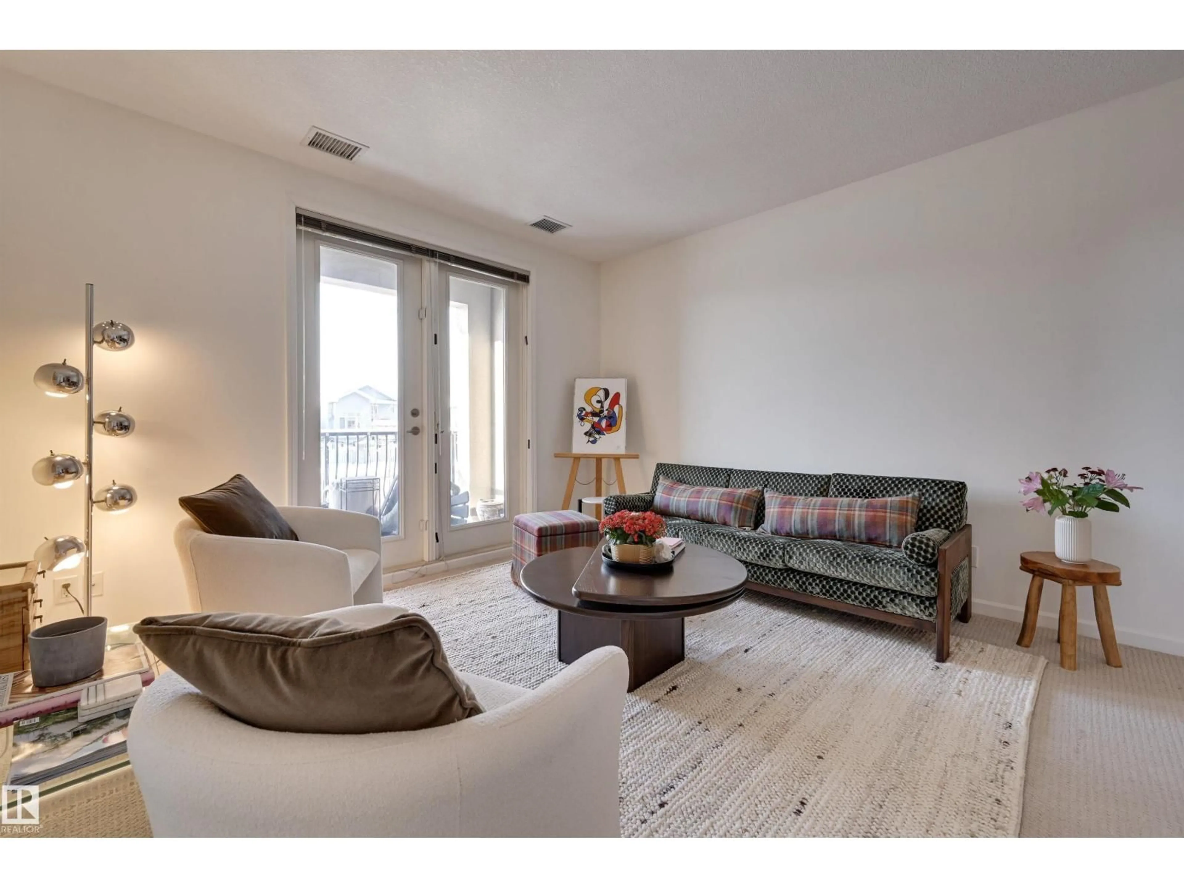 Living room with furniture, wood/laminate floor for 6083 - 221 MAYNARD WY, Edmonton Alberta T6R0S5