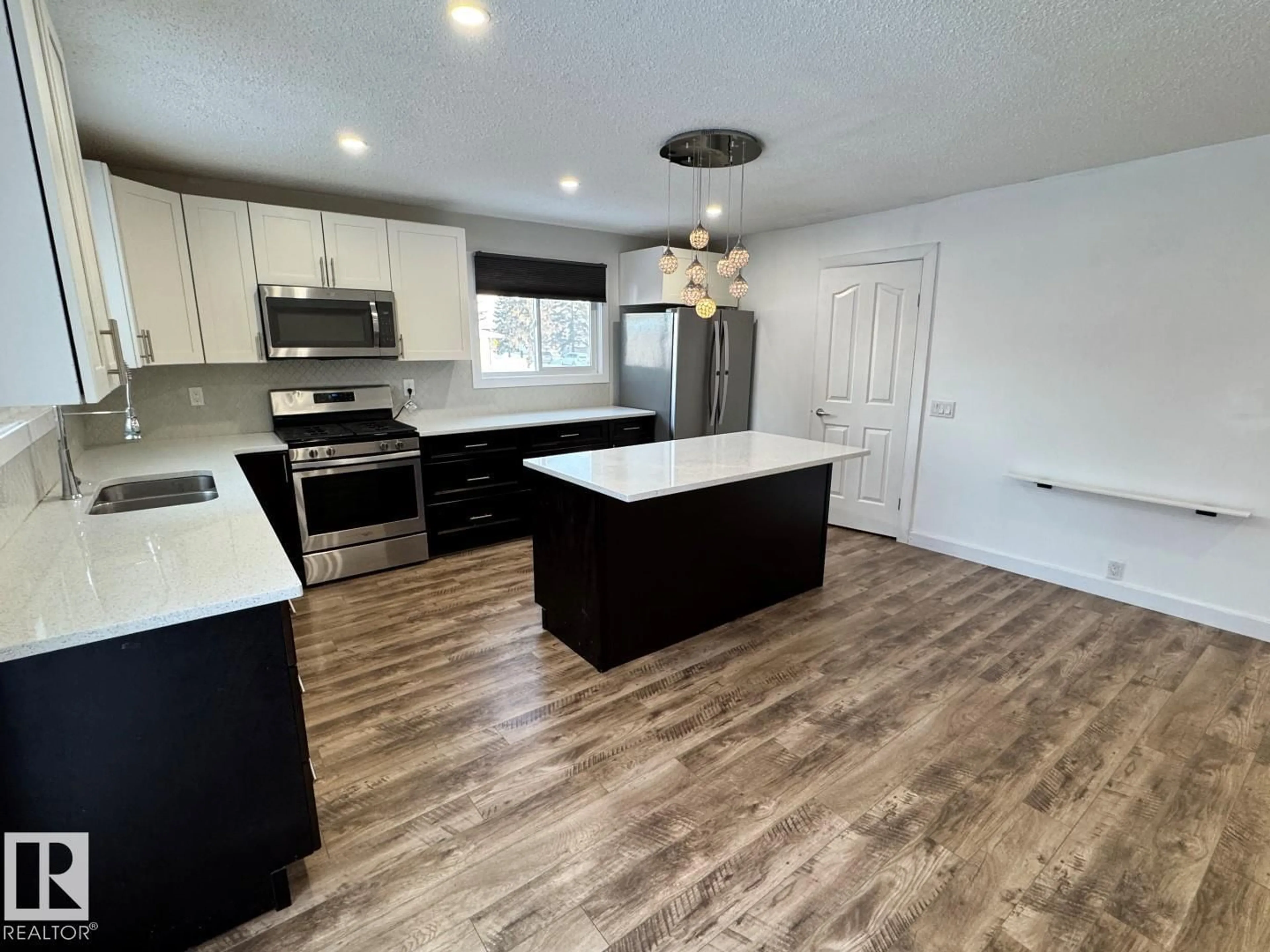 Open concept kitchen, wood/laminate floor for 18404 66 AV, Edmonton Alberta T5T2M2