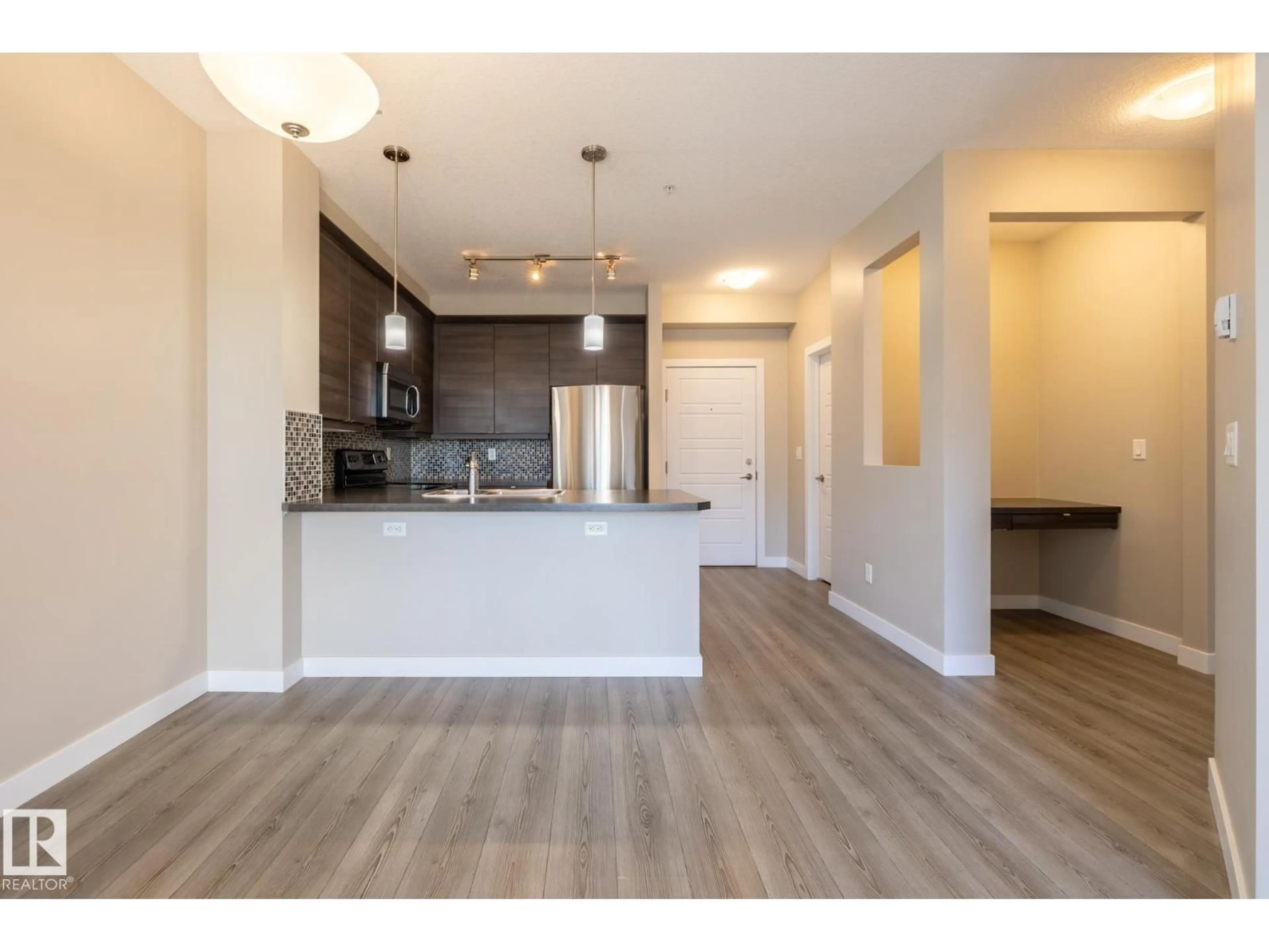 Open concept kitchen, wood/laminate floor for #203 - 2590 ANDERSON WY, Edmonton Alberta T6W0R2