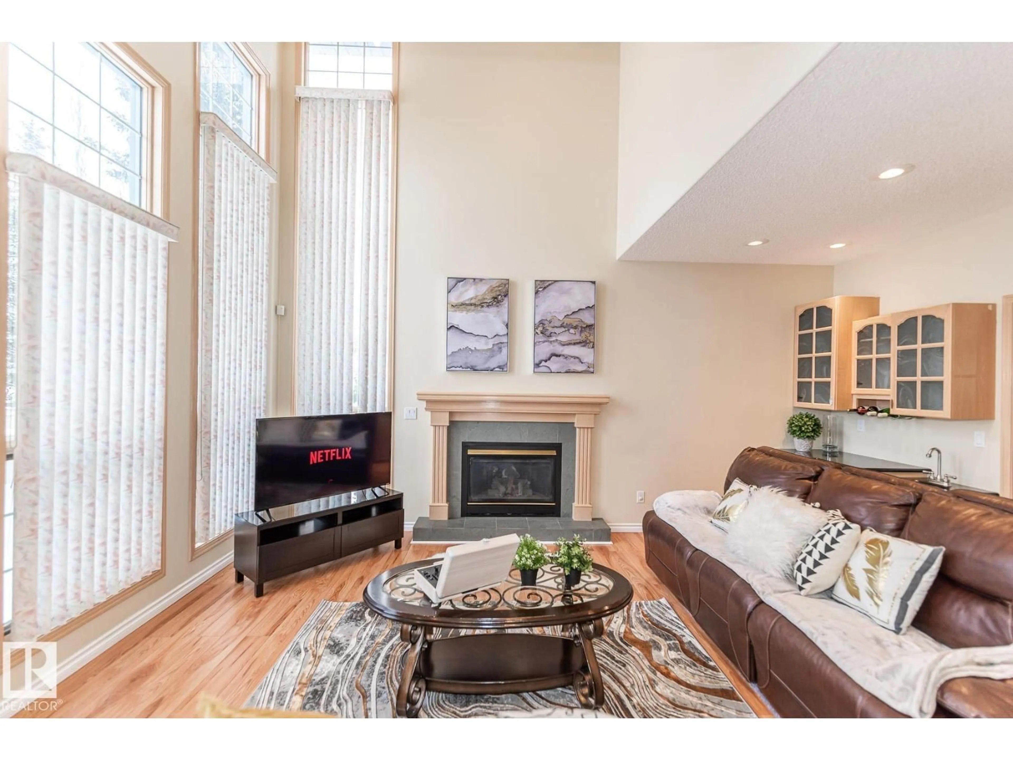 Living room with furniture, wood/laminate floor for NW - 1135 116 ST, Edmonton Alberta T6J6X5