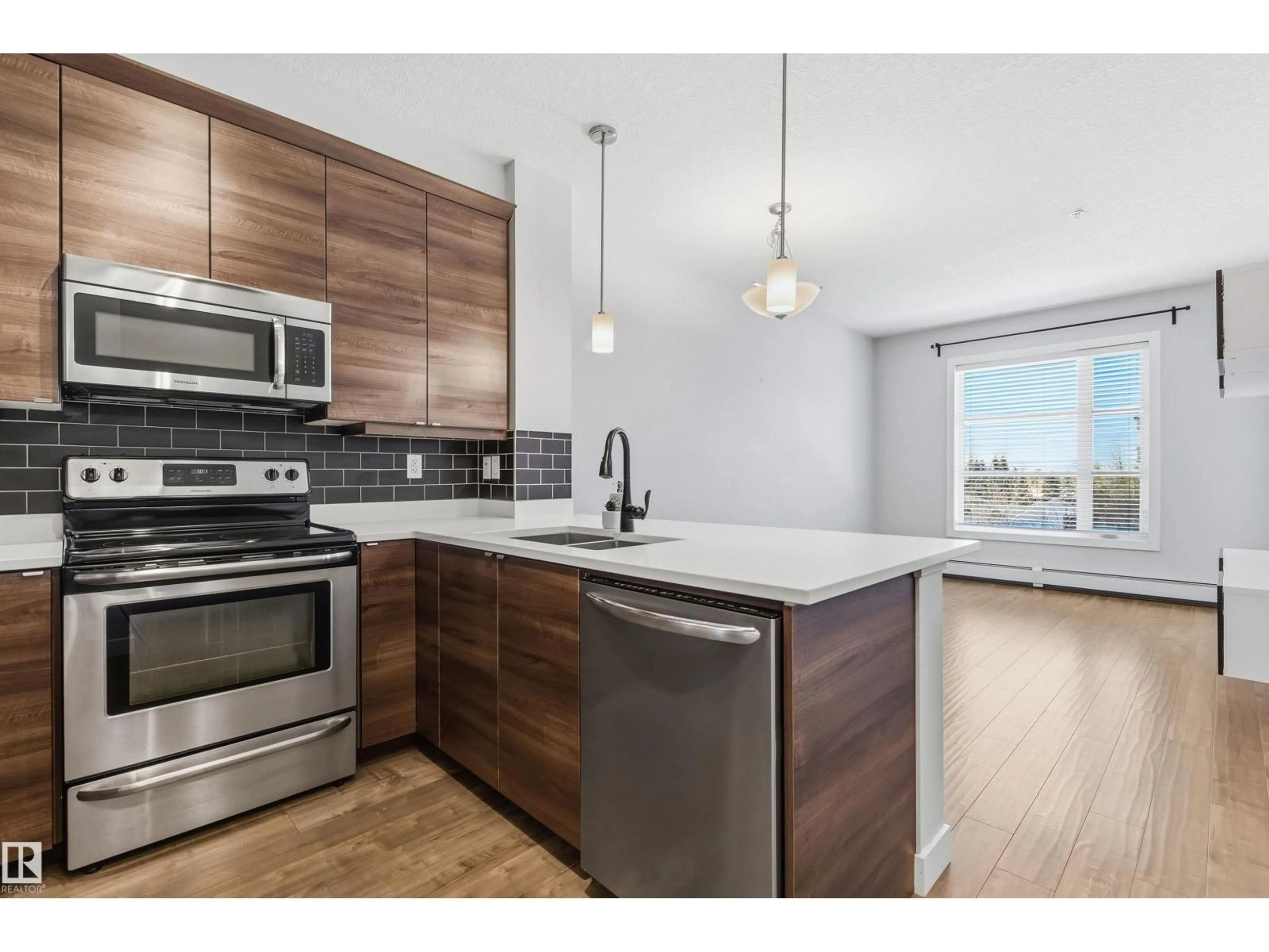 Open concept kitchen, wood/laminate floor for #202 - 2590 ANDERSON WY, Edmonton Alberta T6W0R2