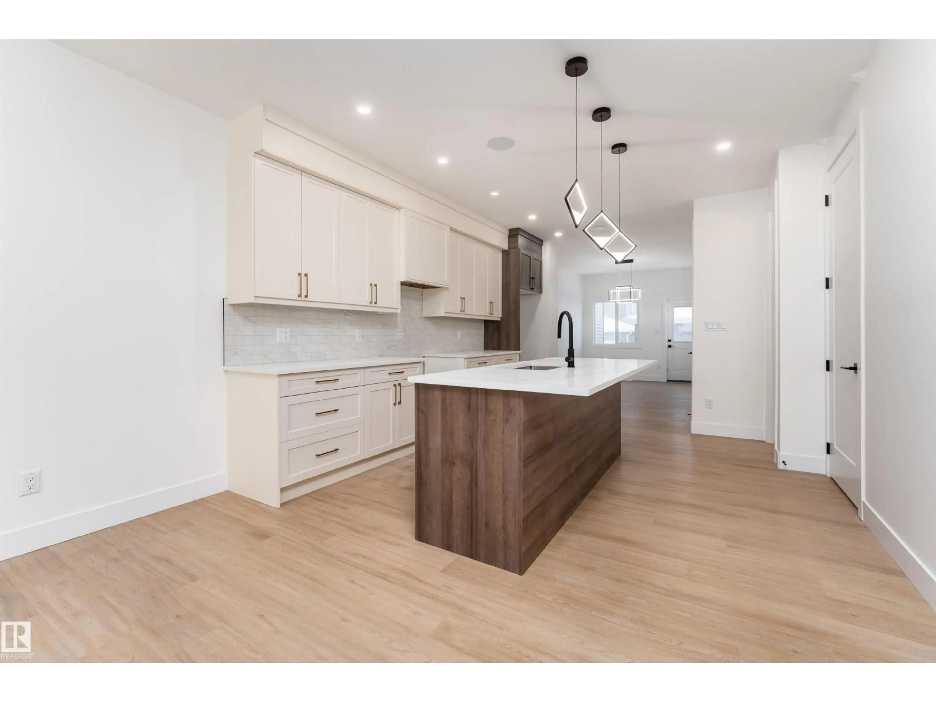 Open concept kitchen, wood/laminate floor for 3103 MAGPIE WY, Edmonton Alberta T5S0V3