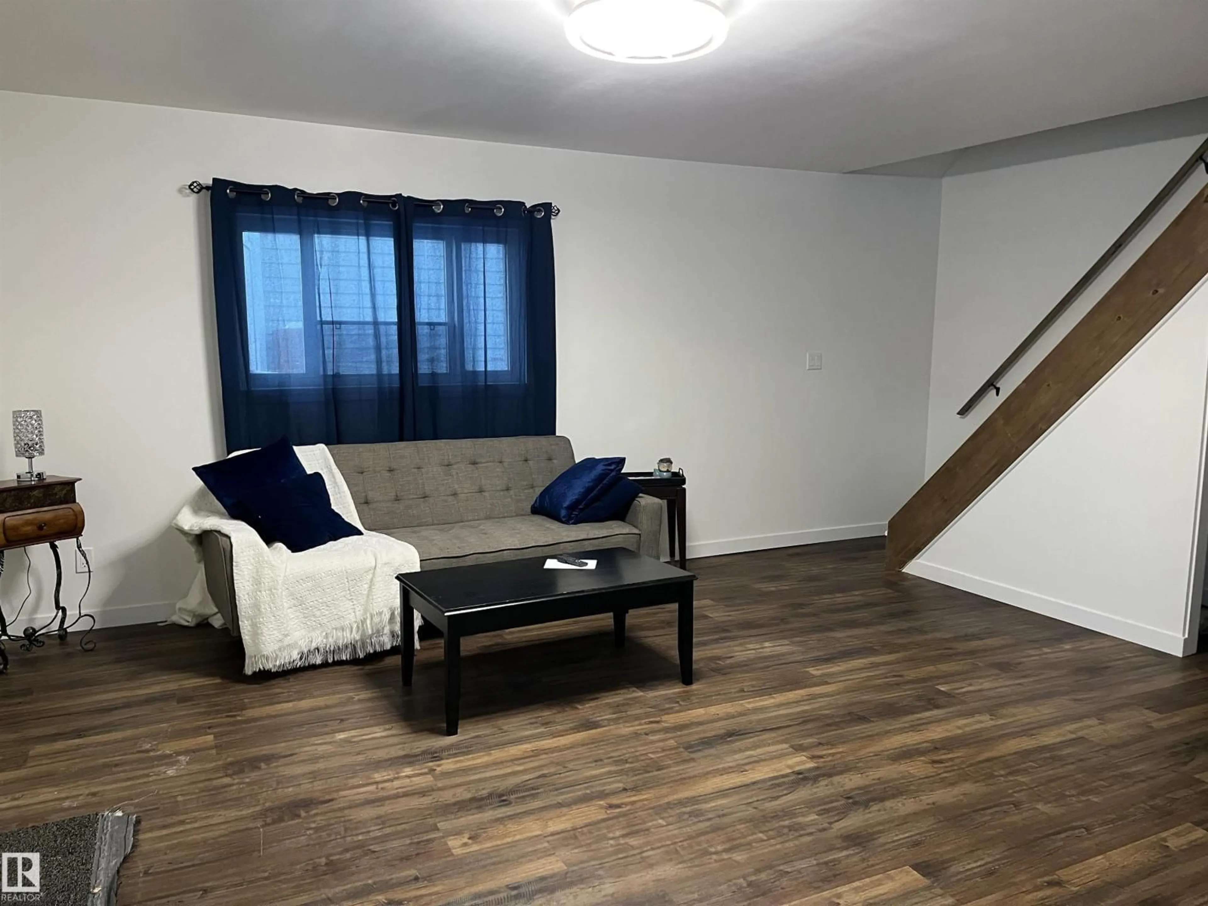 Living room with furniture, wood/laminate floor for 5107 52 AVE, Bonnyville Town Alberta T9N2A6