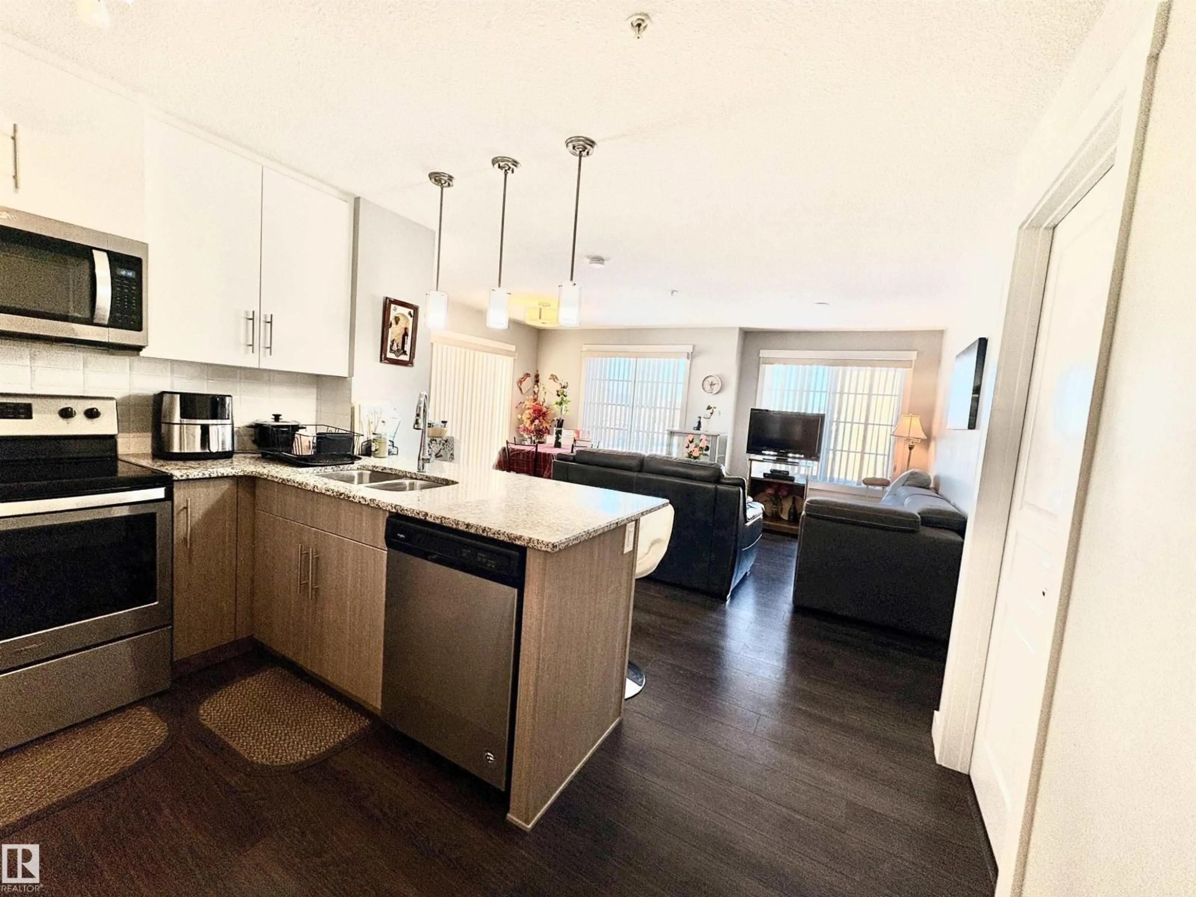 Open concept kitchen, wood/laminate floor for #206 - 3670 139 AV, Edmonton Alberta T5Y3N5