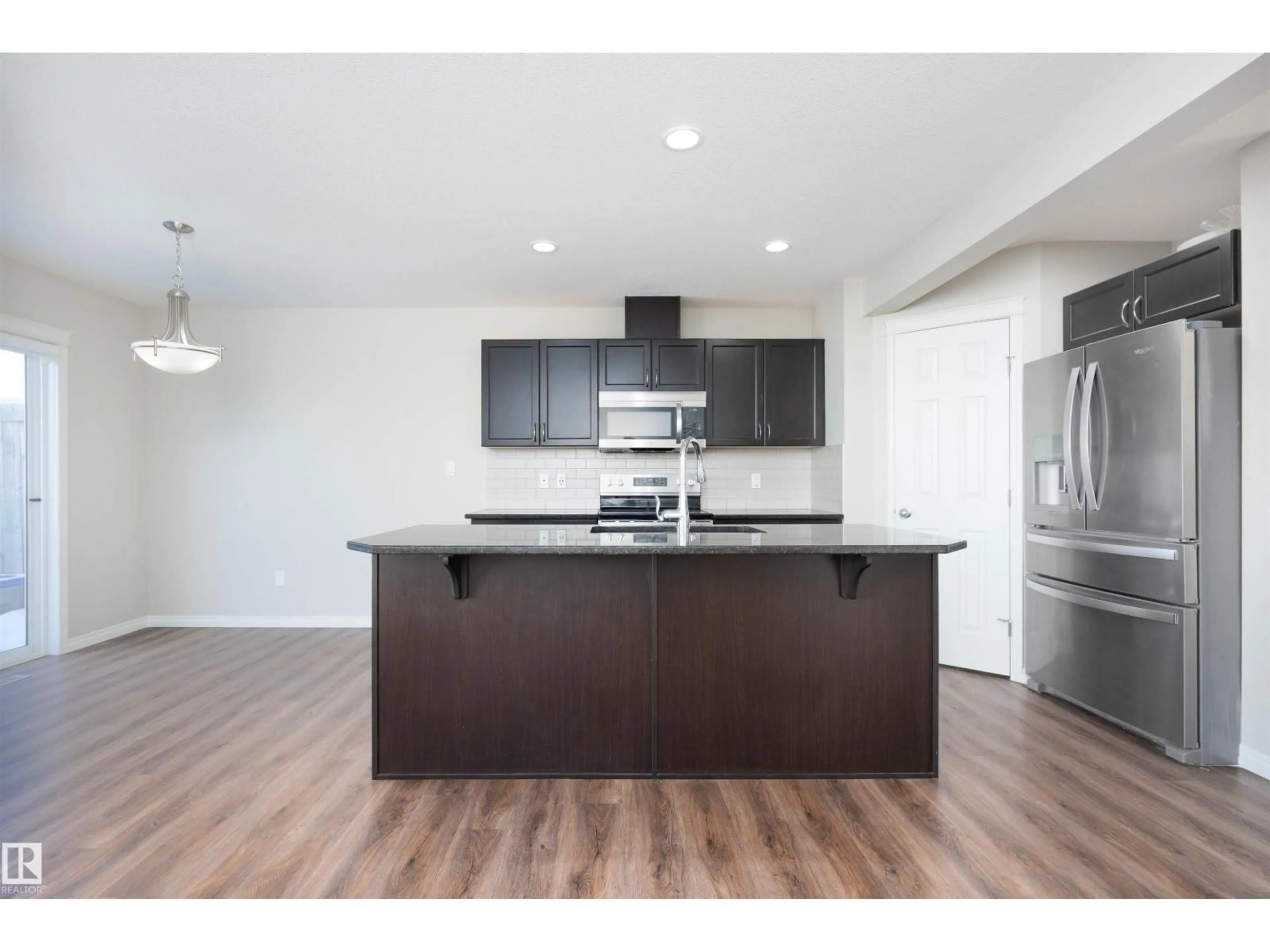 Open concept kitchen, wood/laminate floor for SW - 5206 20 AV, Edmonton Alberta T6X1V6
