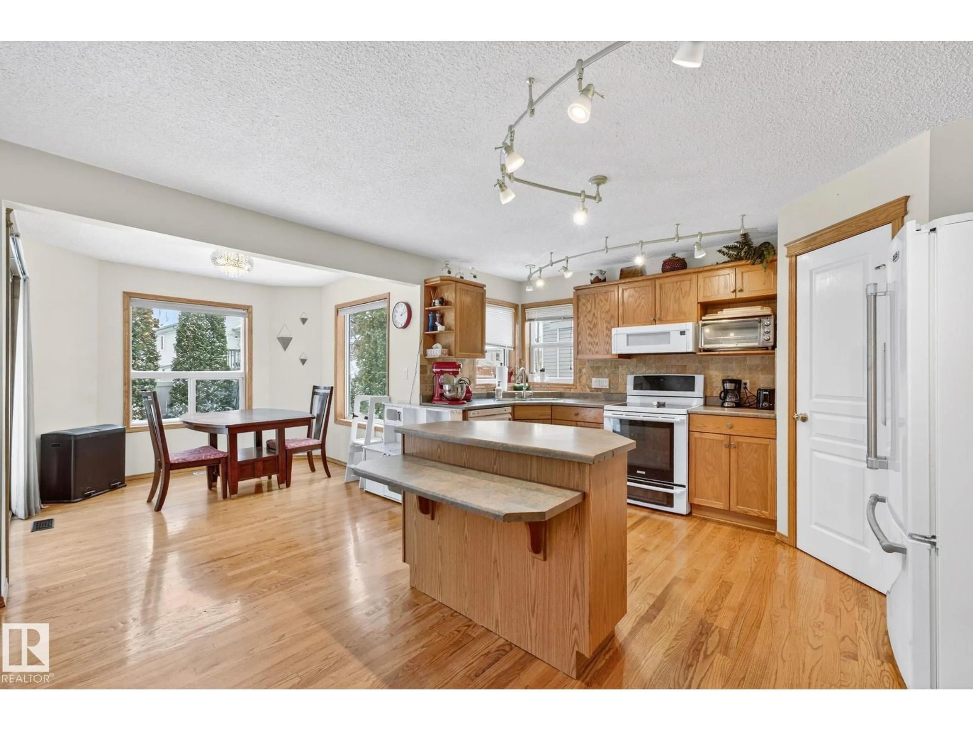 Open concept kitchen, wood/laminate floor for NW - 4027 31 ST, Edmonton Alberta T6T1L3